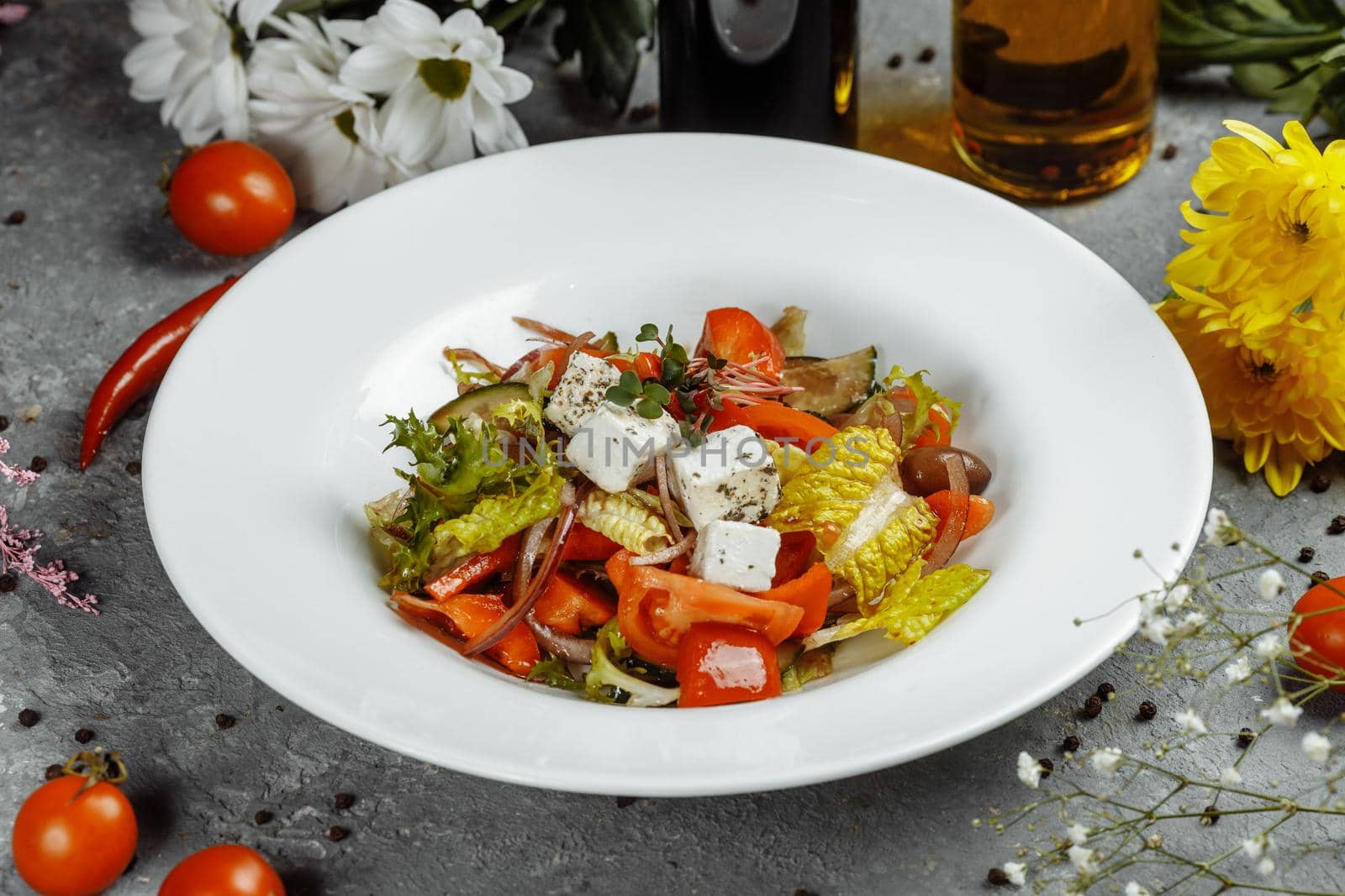 Greek salad with fresh vegetables, feta cheese and black olives.