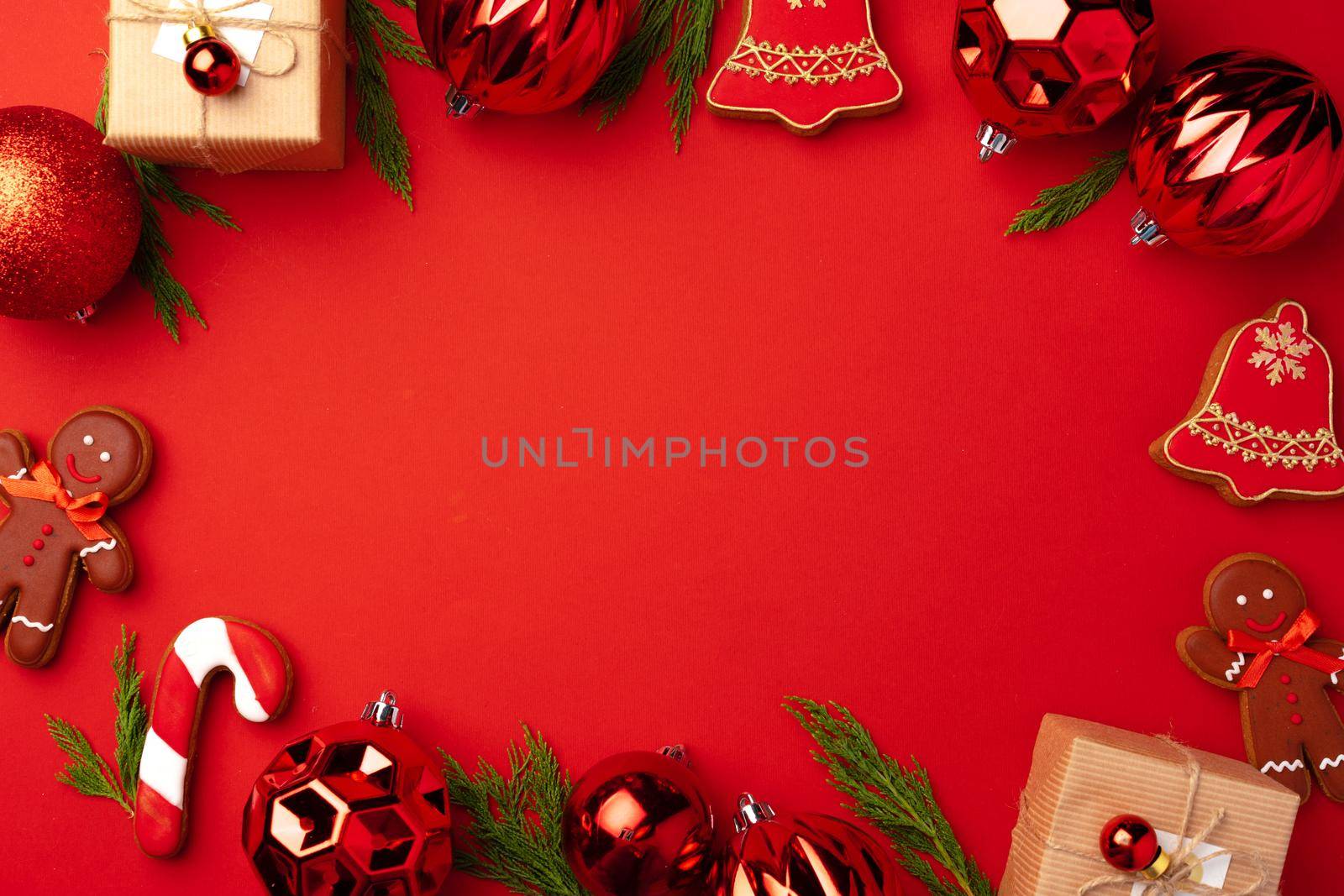 New Year background with festive decorations and gingerbread cookies on red