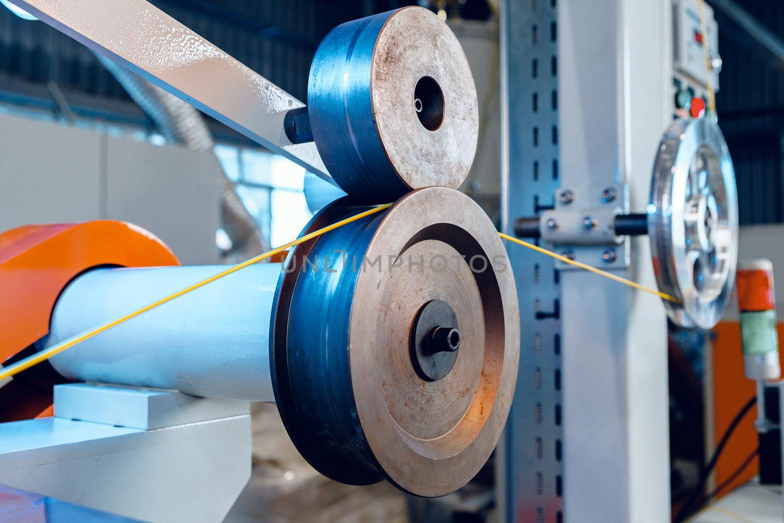 Inside a modern plant producing power electric cables and optical fibers. .Cable manufacturing machine part. Close up.