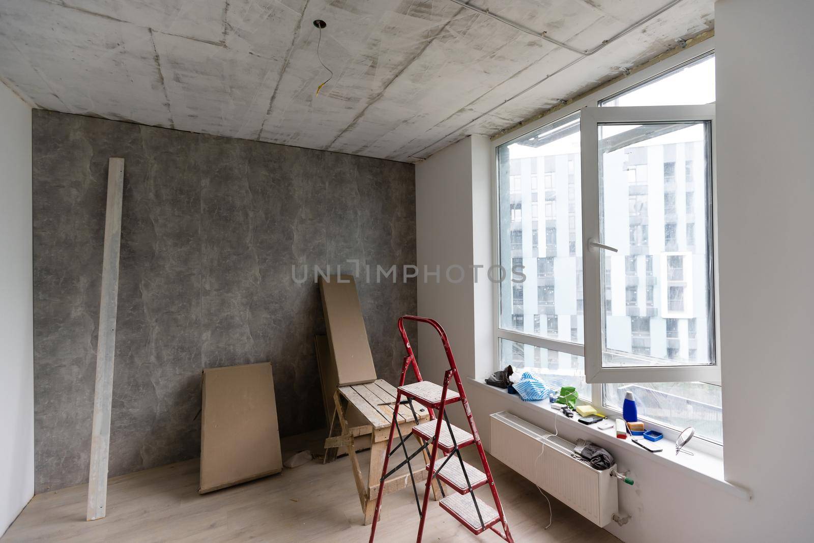 Home renovation in room full of painting tools