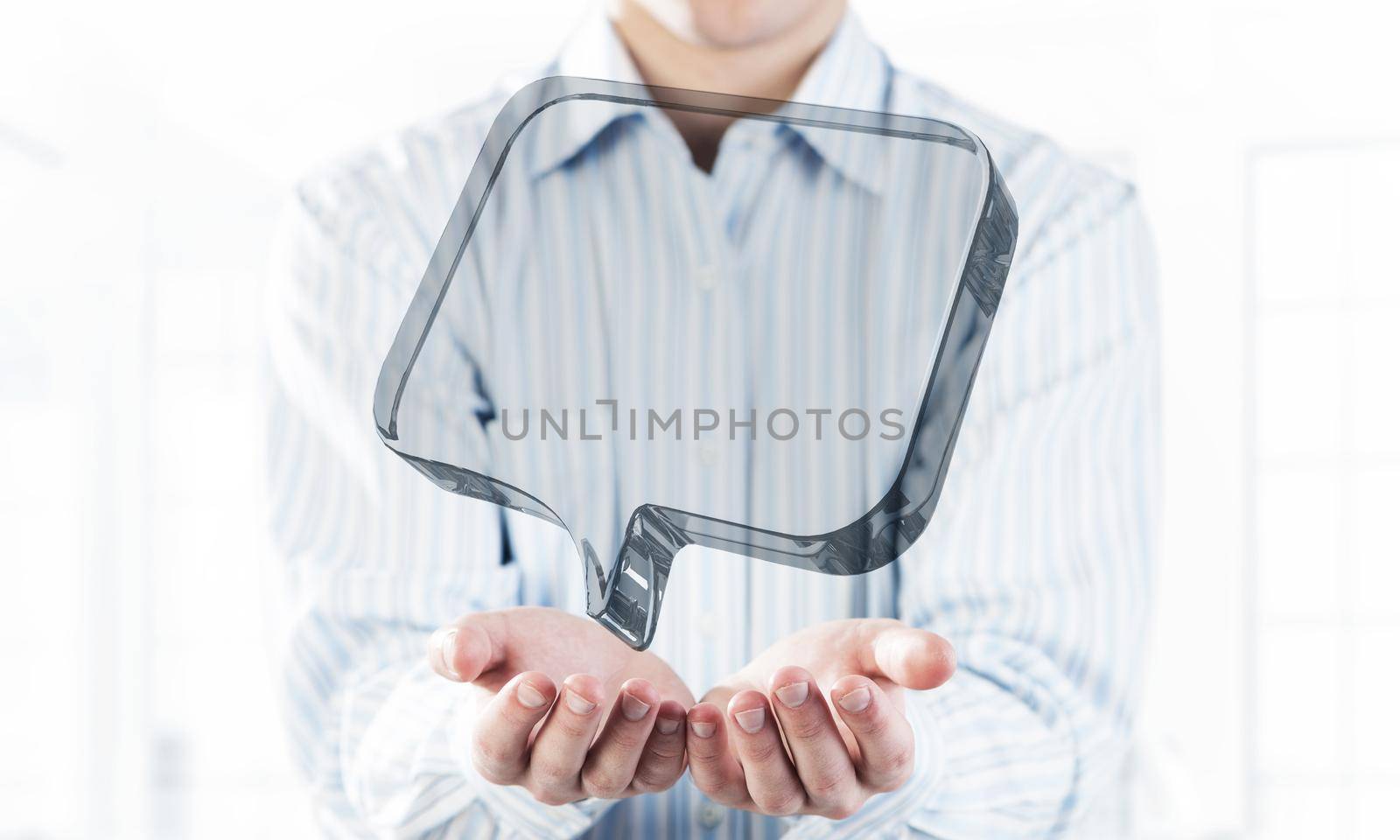 Close of businessman hands showing glass speech bubble as internet concept. Mixed media
