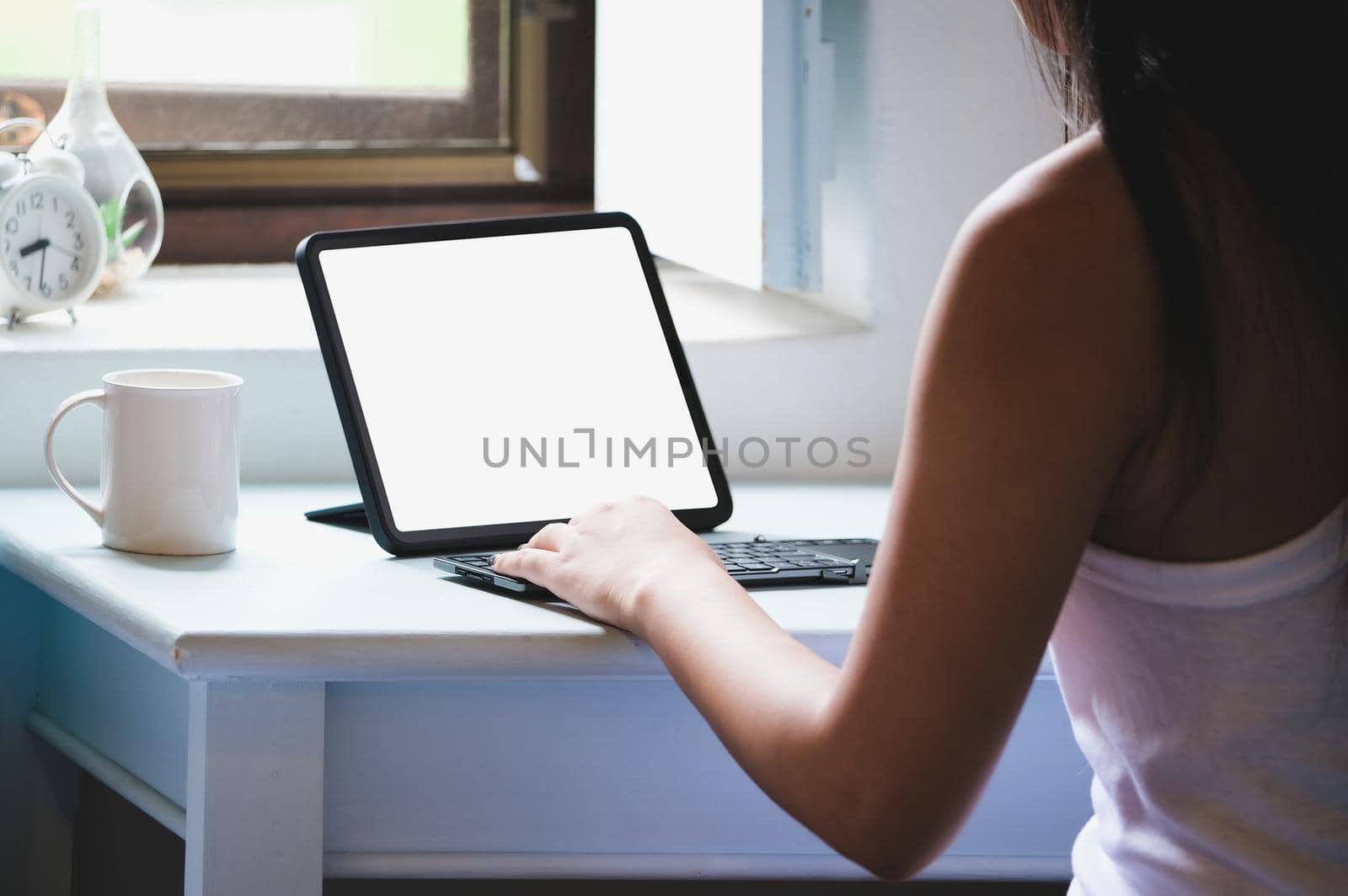 Business Women use a tablet for work, a blank tablet screen can add text or other media. by Manastrong