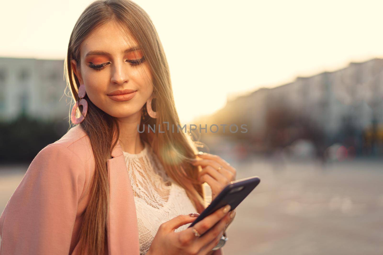 Close up portrait of a young woman talking on her phone in the street. Close up.
