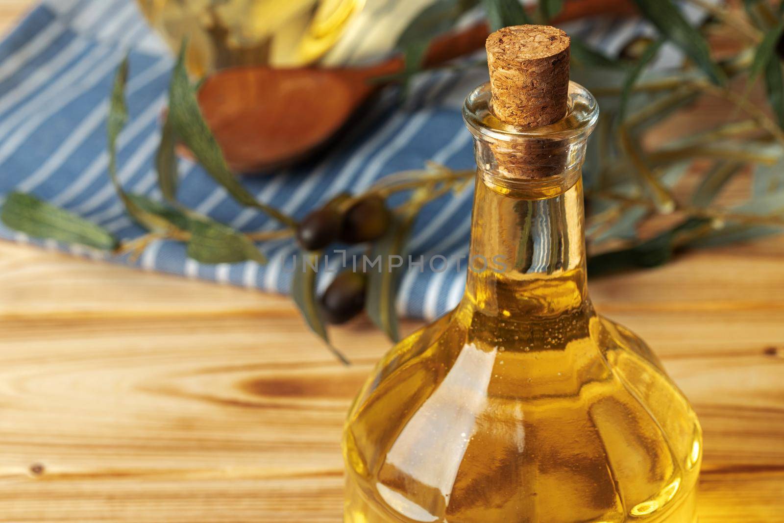 Olive oil bottle on wooden table.