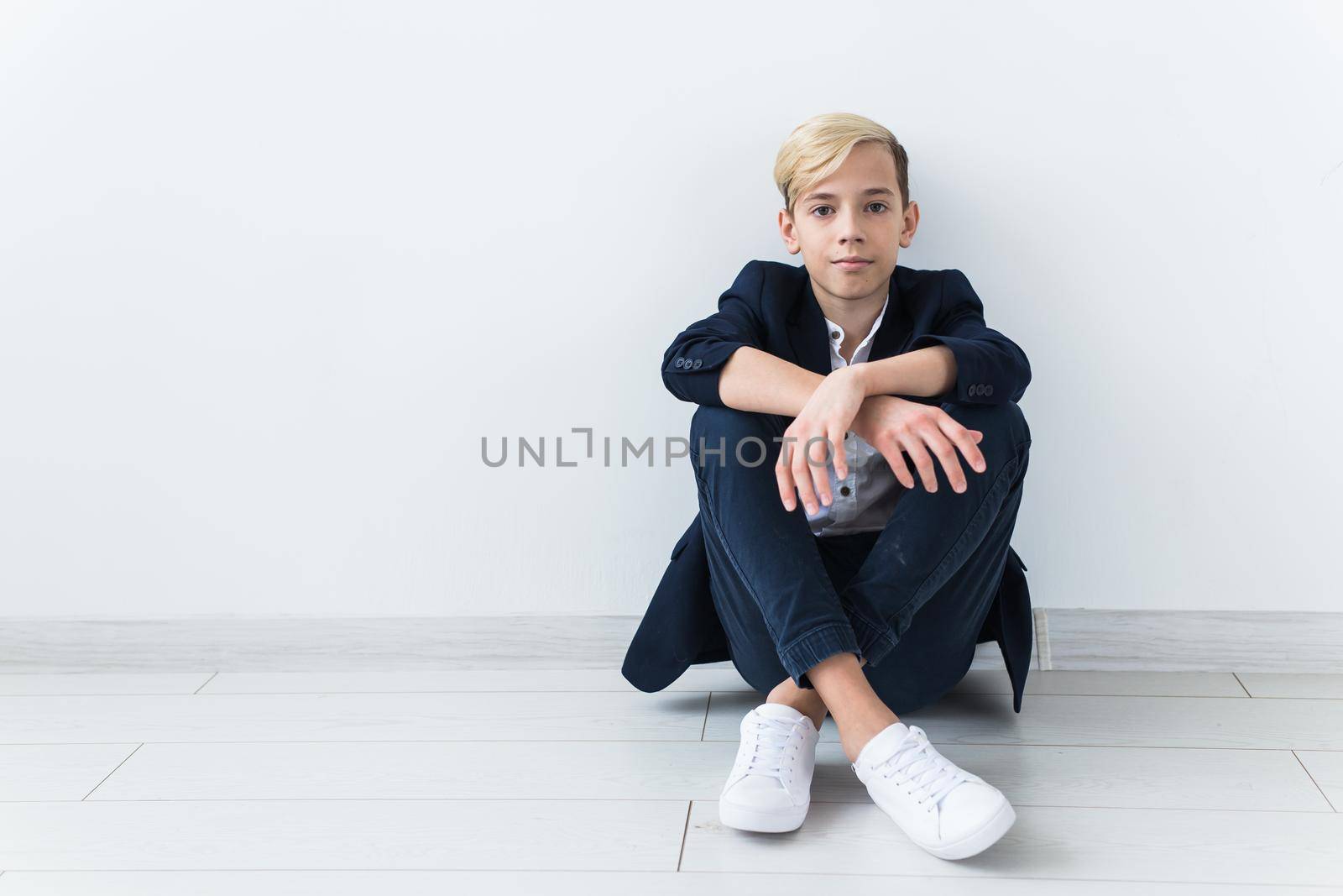 Teenage depression and puberty concept - Sad teenager portrait close up on white.