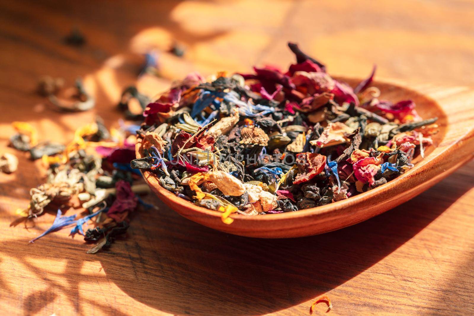 Handful of natural tea on a wodden surface
