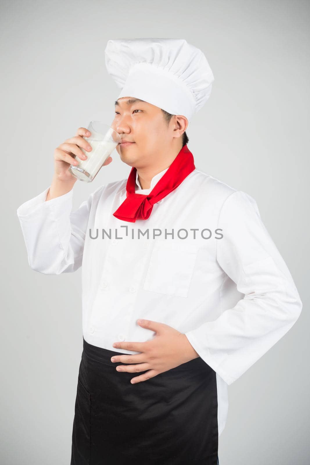 chef holding glass cup and drink yogurt or milk by whatwolf