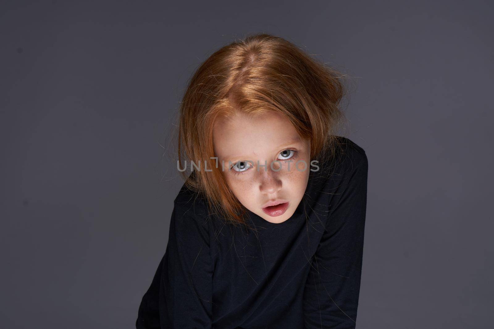 red-haired girl with freckles on her face in a black sweater posing by Vichizh