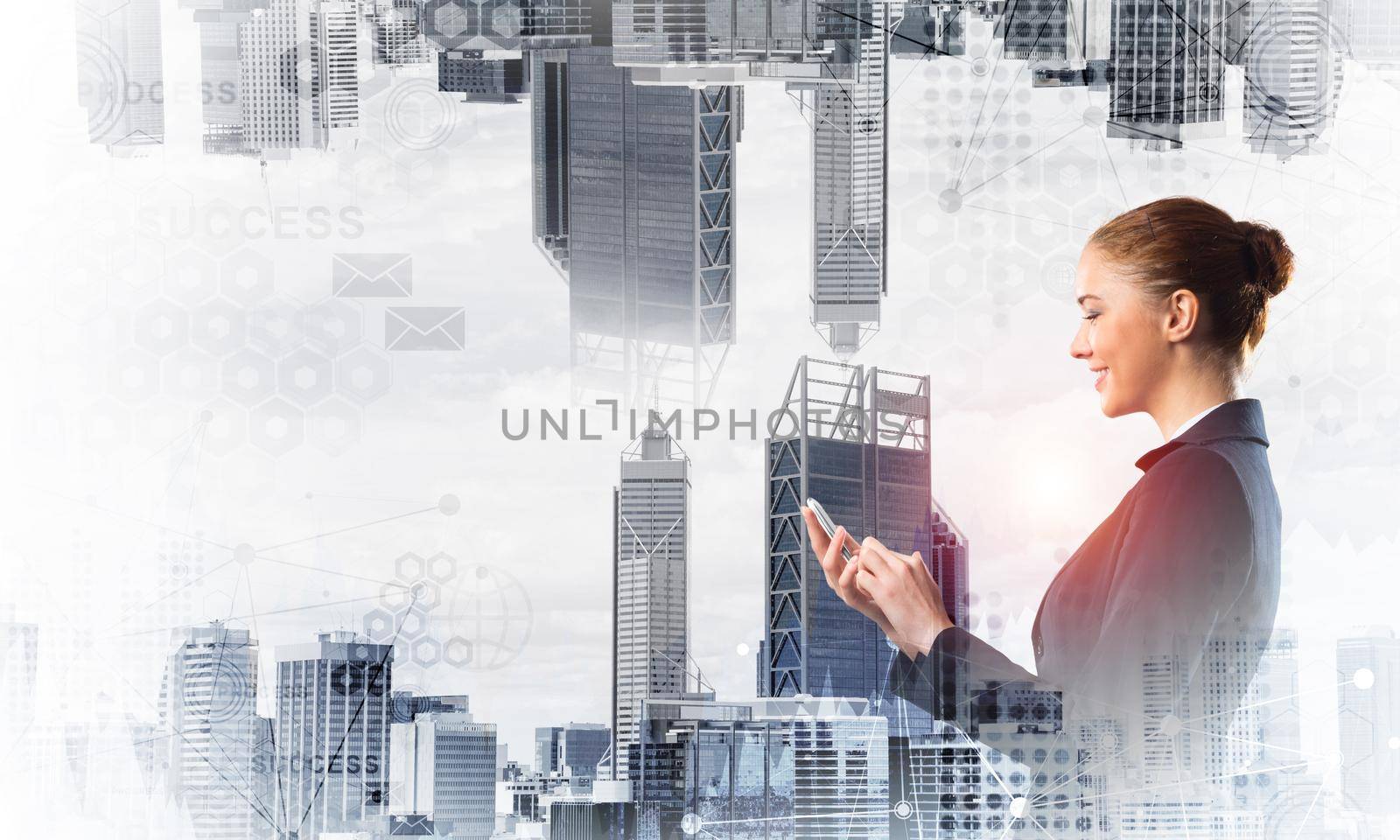 Young businesswoman using mobile phone. Double exposure concept with modern downtown architecture and beautiful woman in business suit. Digital technology in property management and development.