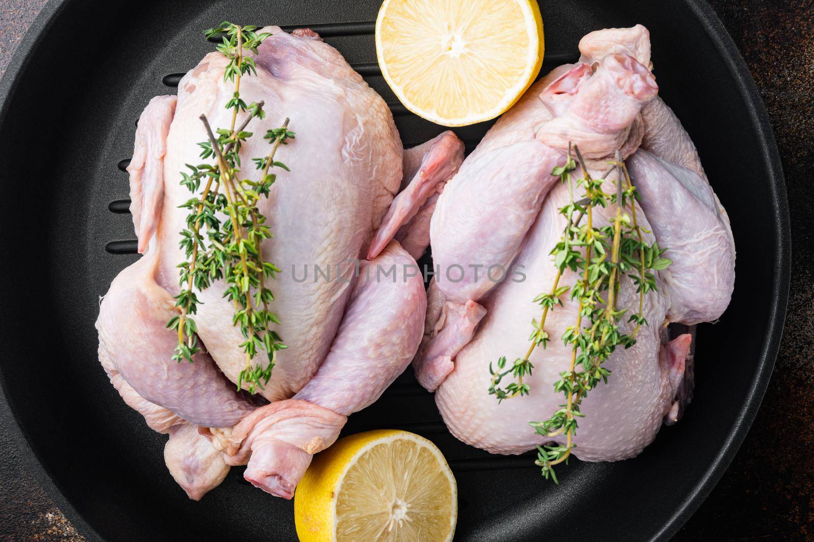 Raw organic uncooked whole chicken meat on grill pan, on old rustic background, top view