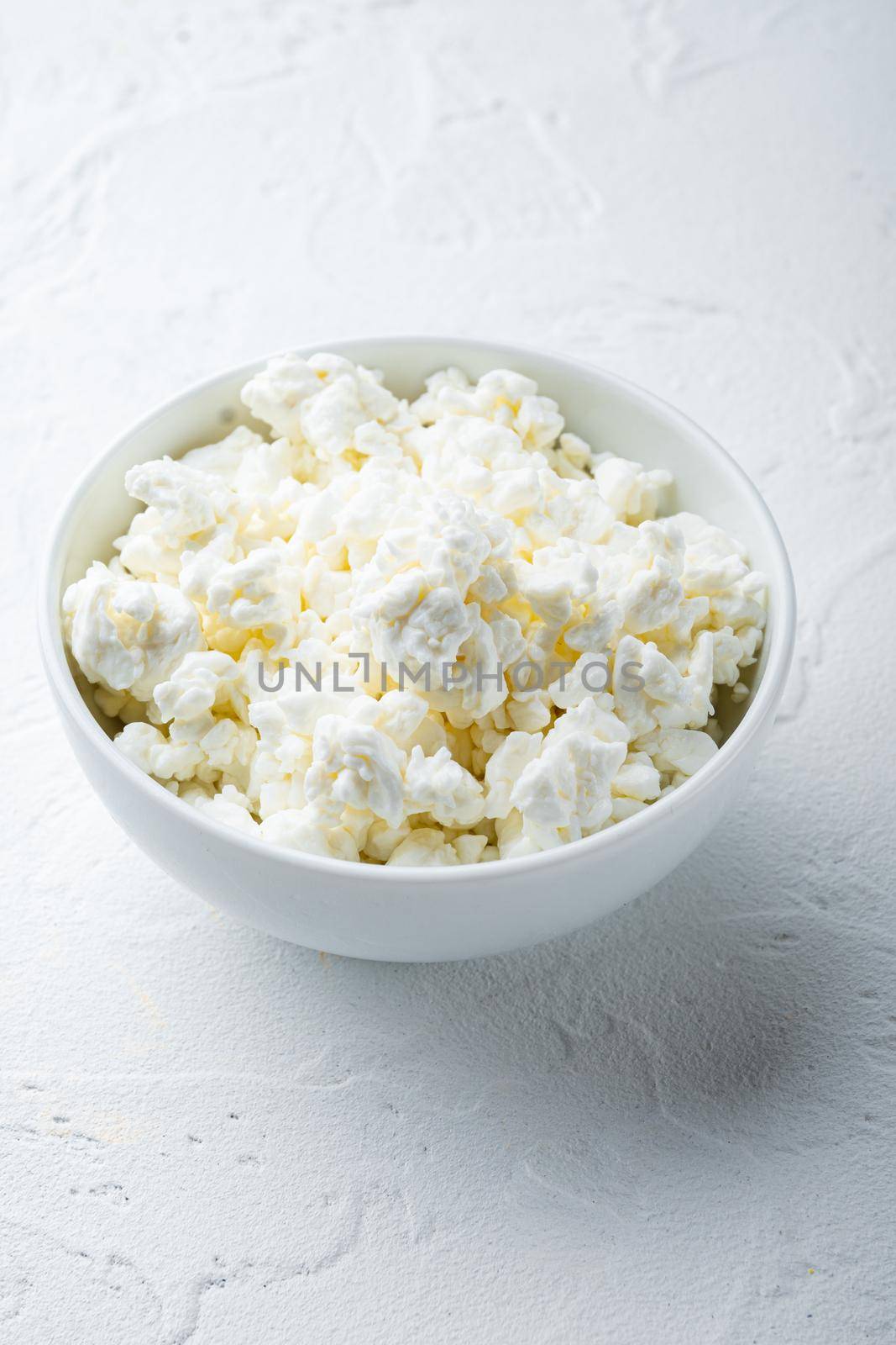 Cottage cheese, curd, on white textured background