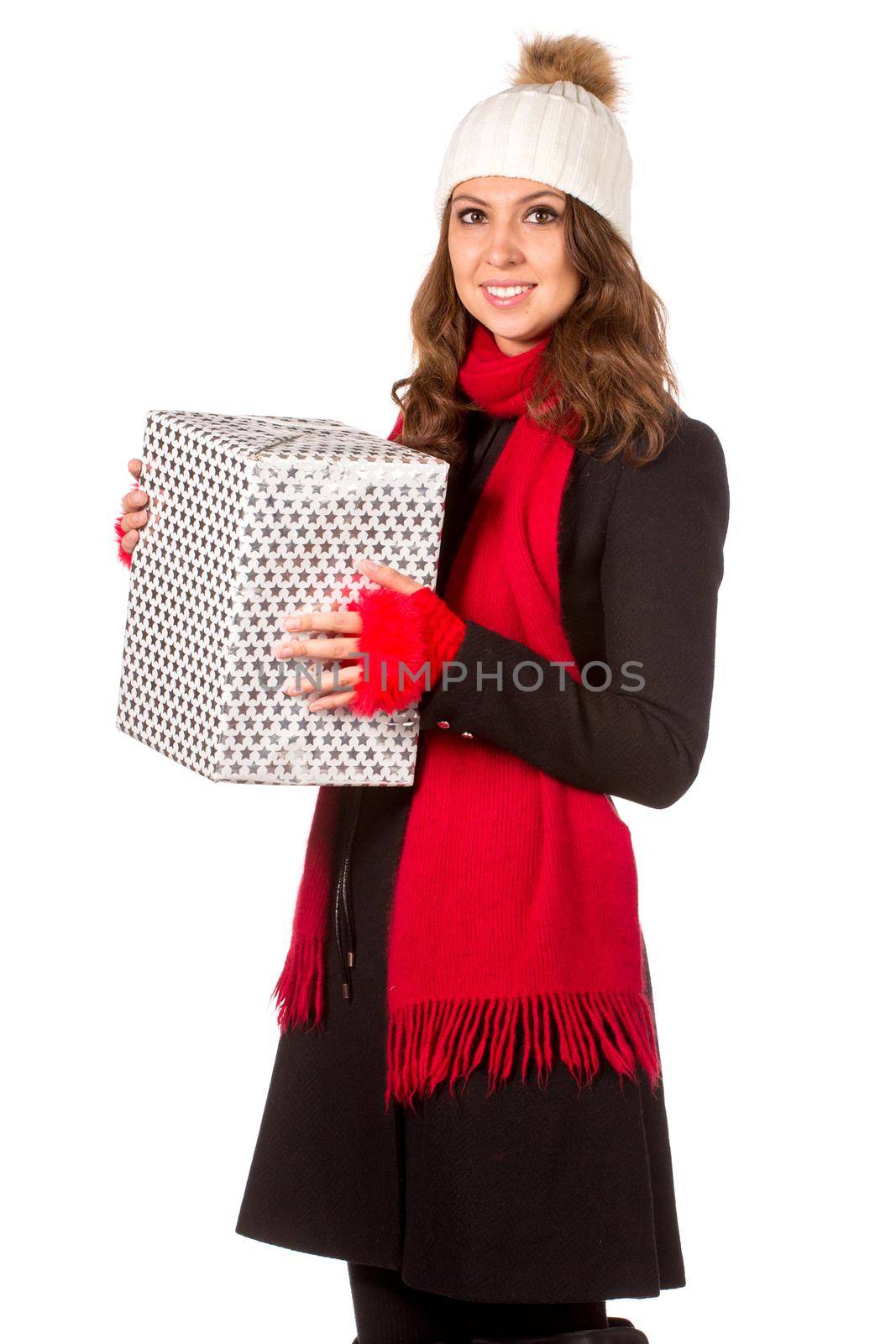 Young and beautiful woman holding a nice Christmas present. Isolated on white.