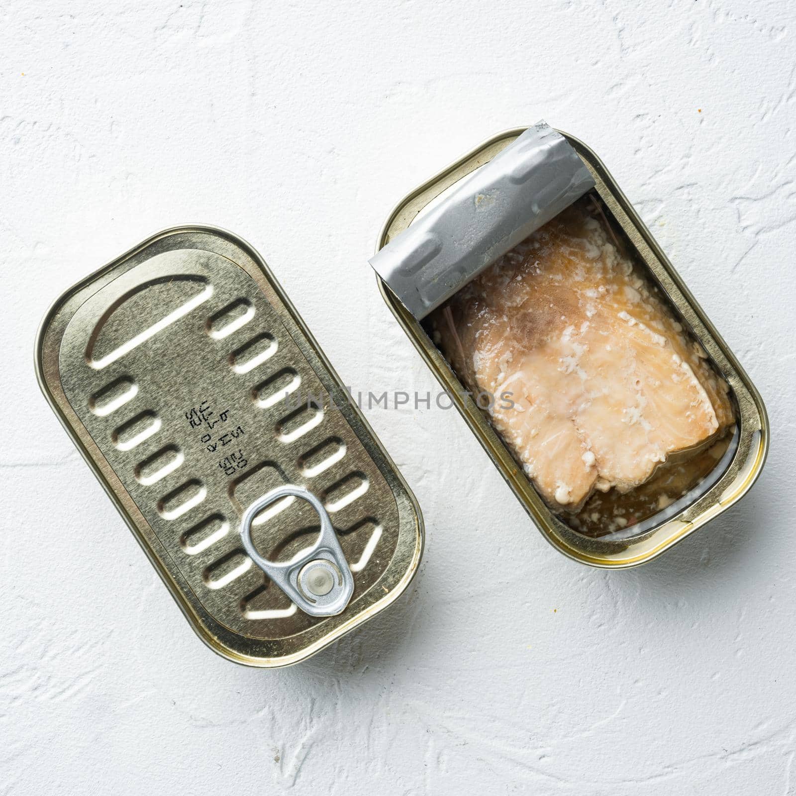 Canned salmon, fish preserves, in tin can, on white background, top view flat lay, square format by Ilianesolenyi