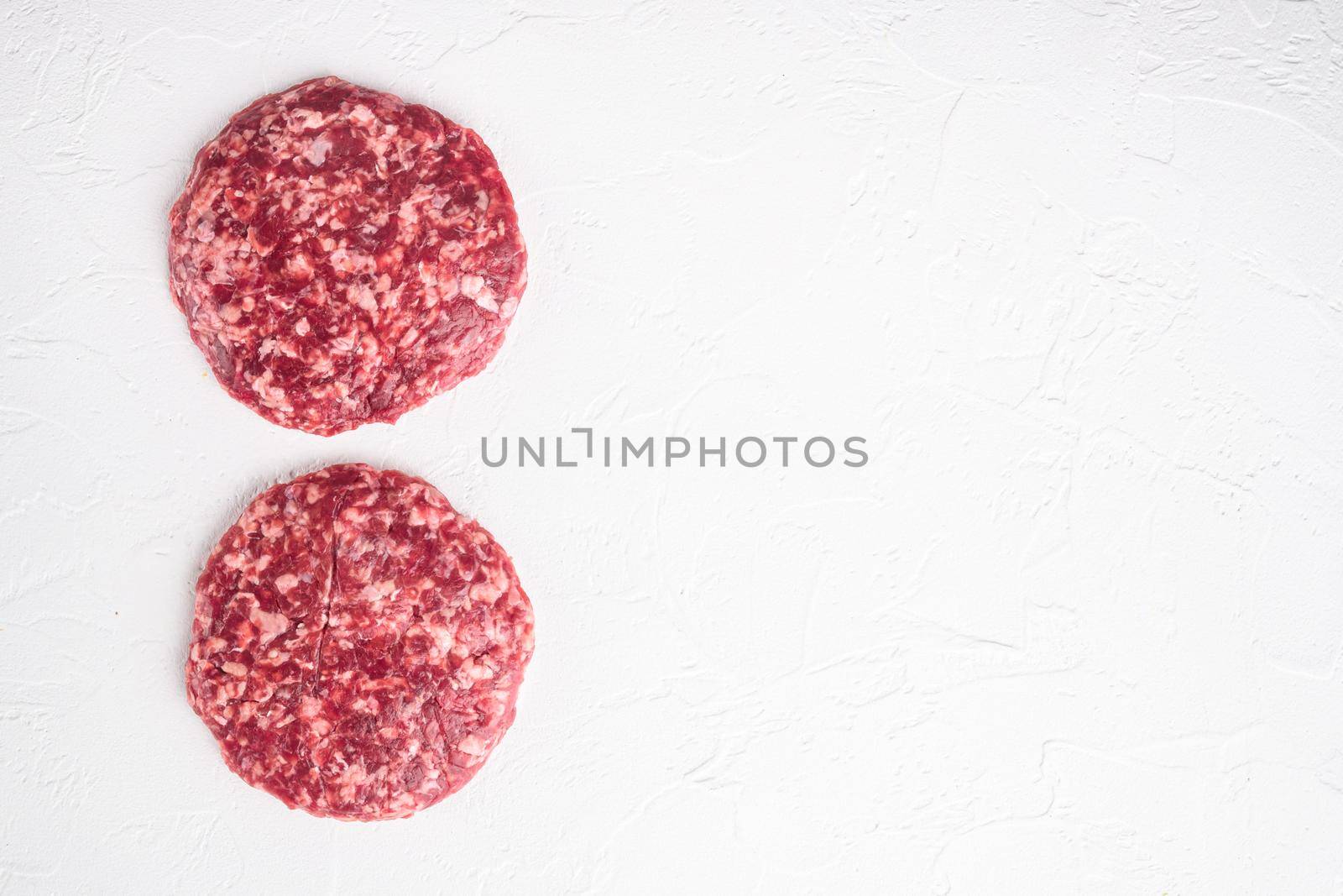 Patty of minced meat for burger set, on white stone background, top view flat lay, with copy space for text