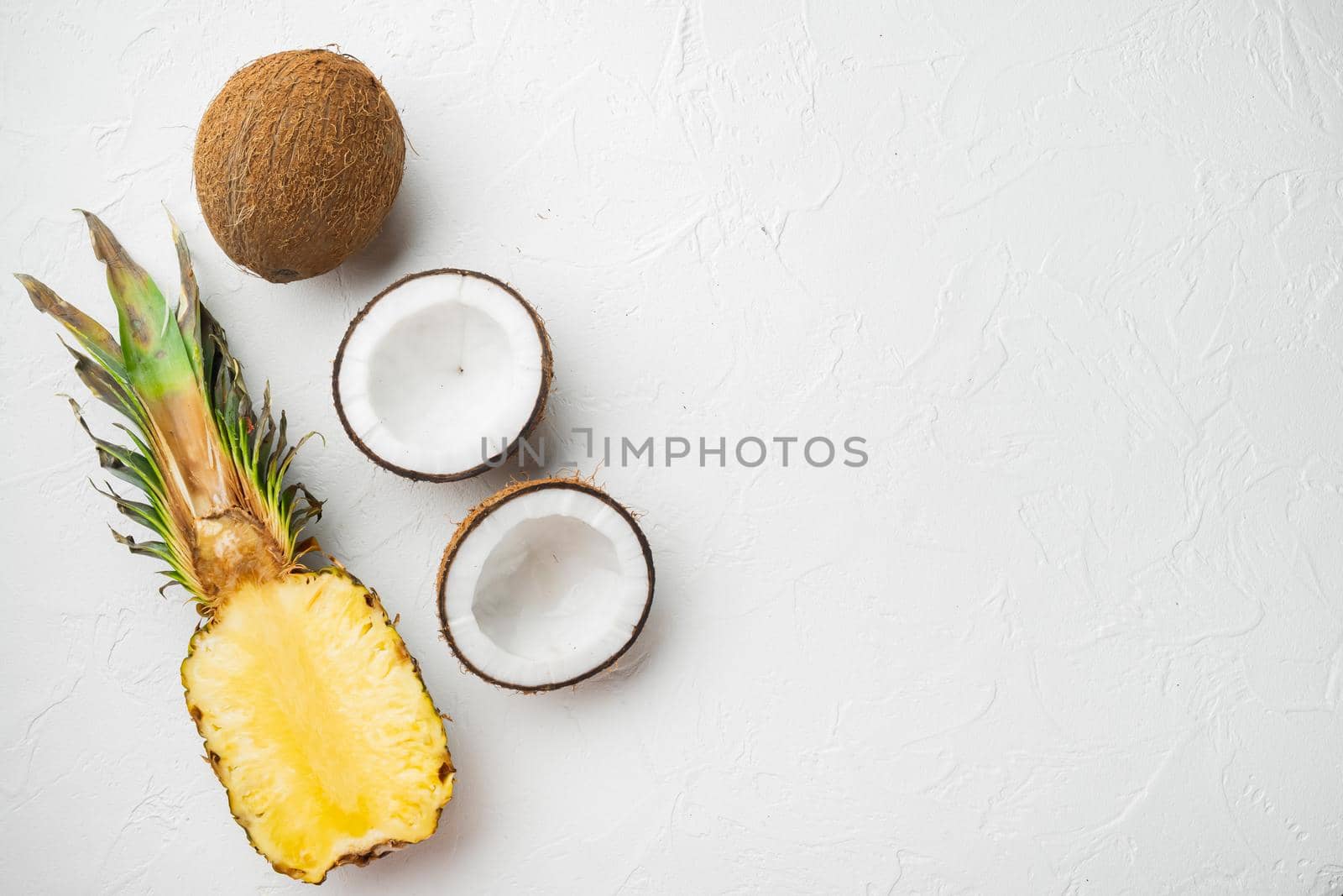 Creative layout made of Exotic and tropical fruits, pineapple and Coconut set, on white stone table background, top view flat lay, with copy space for text