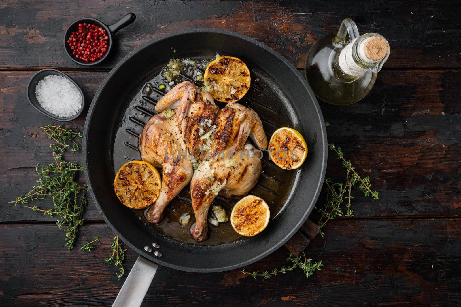 Roasted golden chicken, on old wooden table, top view