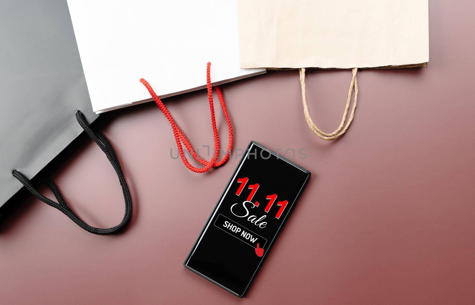 China 11.11 single day sale concept, smartphone with shopping bag. by psodaz