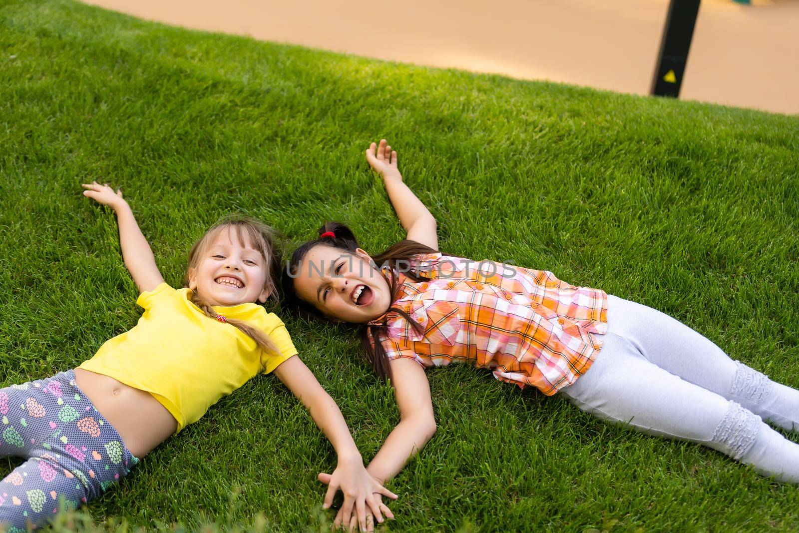 happy excited kids having fun together on playground by Andelov13