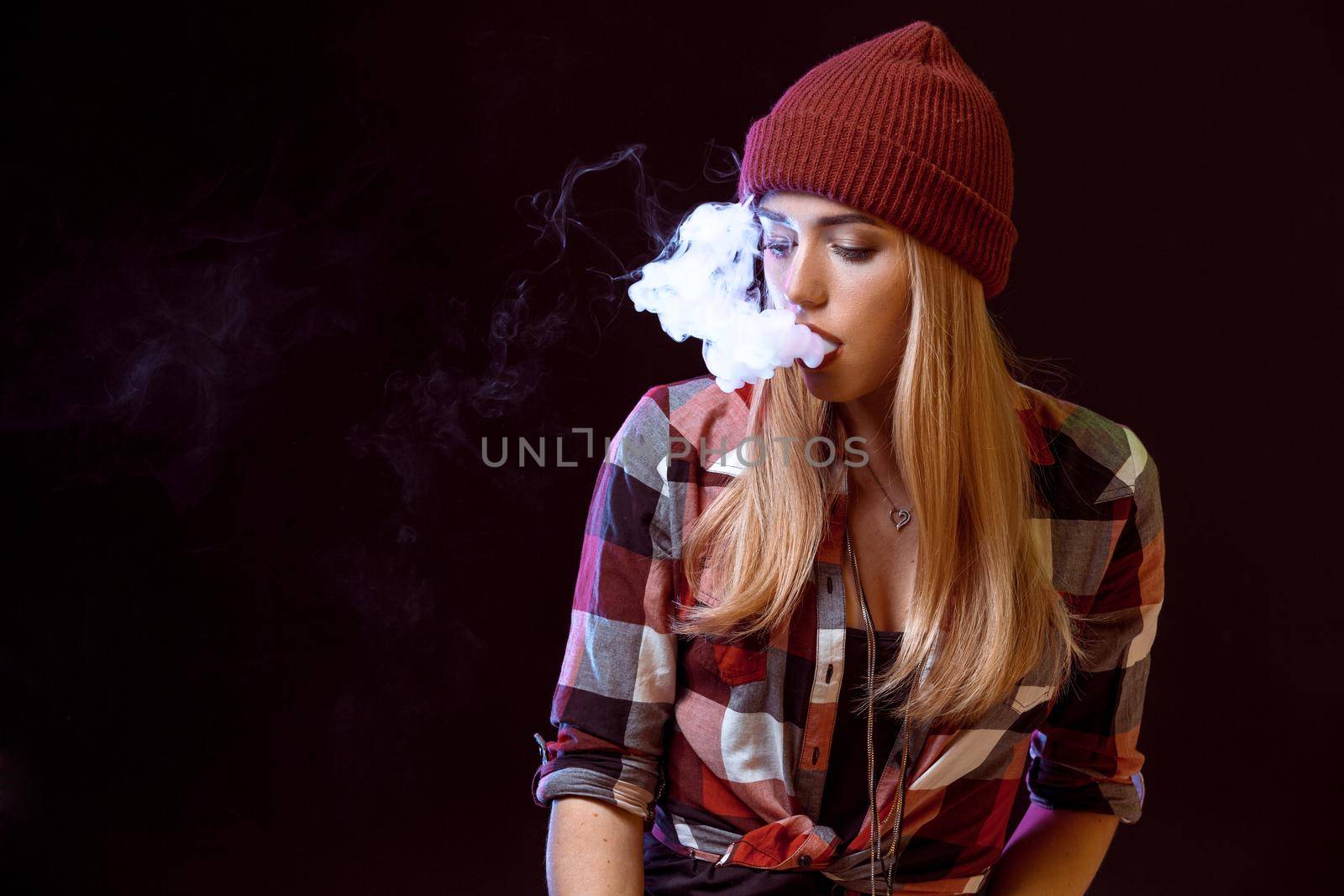 young woman smoking electronic cigarette by nazarovsergey