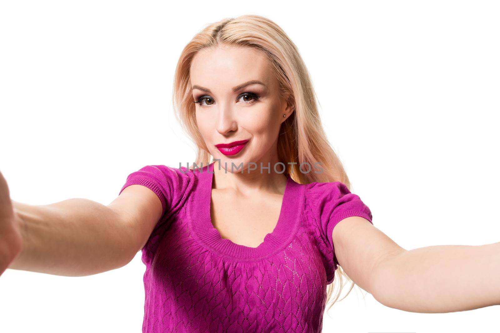 Smiling cheerful blond-haired woman doing selfie on isolated white background. Taking picture.