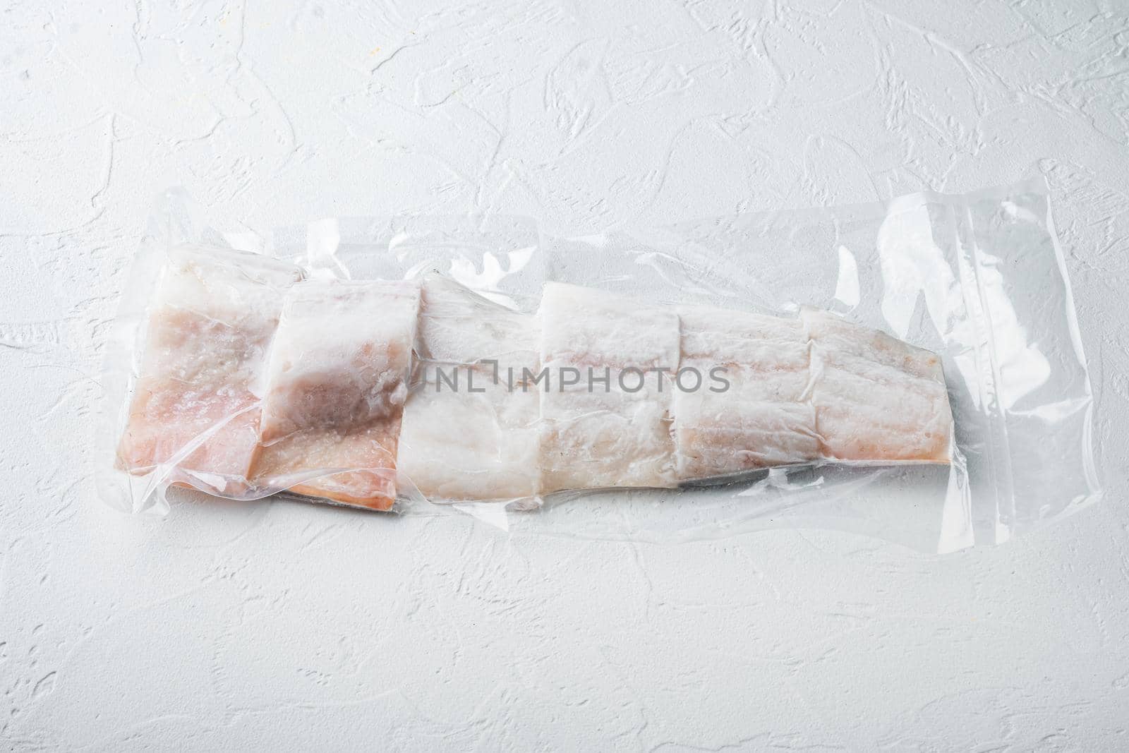 Haddock fish skinless in vacuum package, on white background with copy space for text
