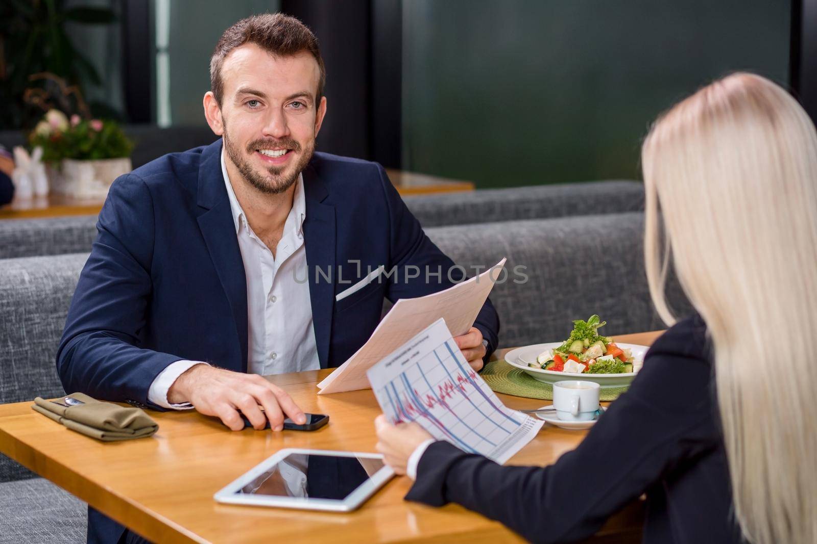 A woman and a man on a business lunch in a restaurant