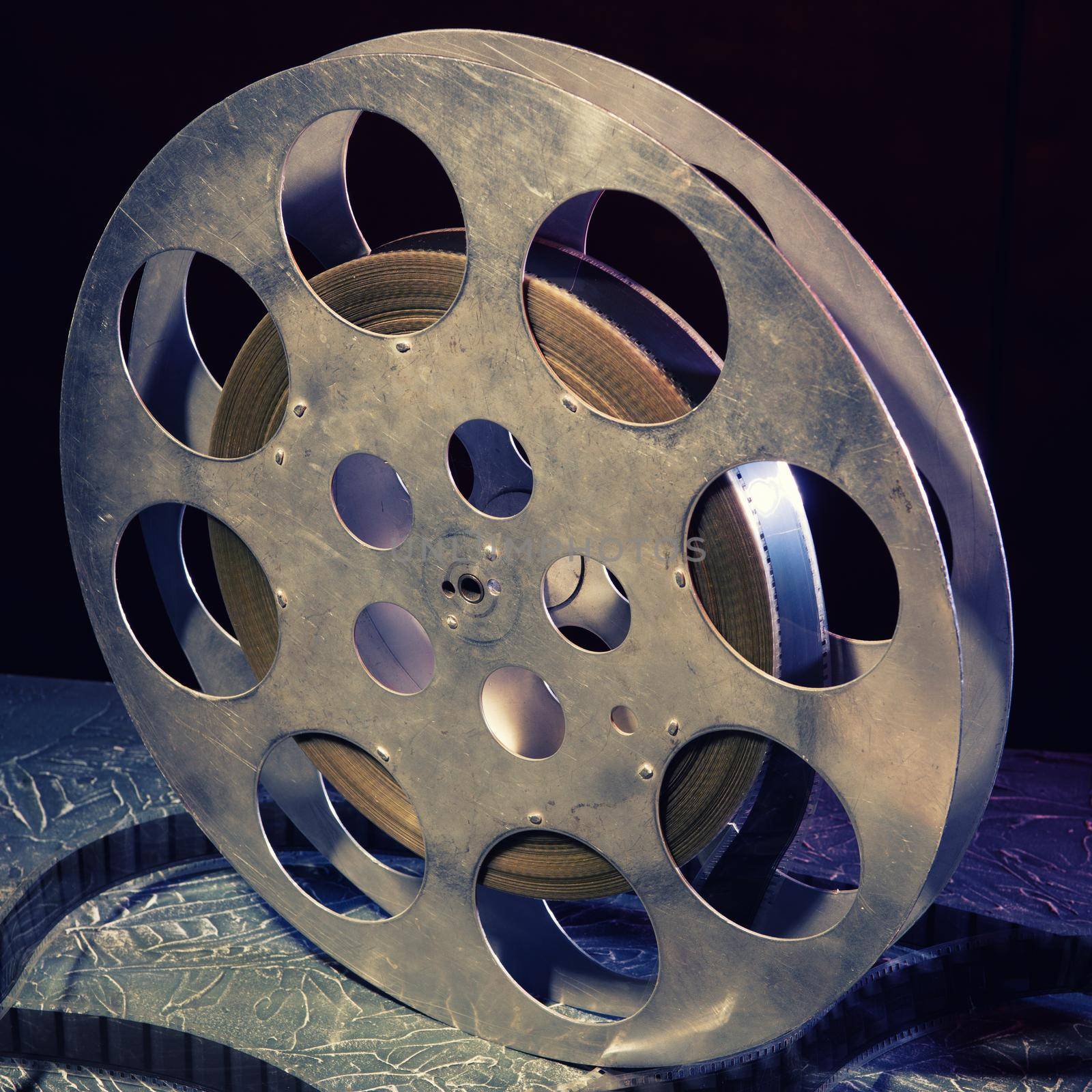 35 mm film reel with dramatic lighting on a dark background - image toned