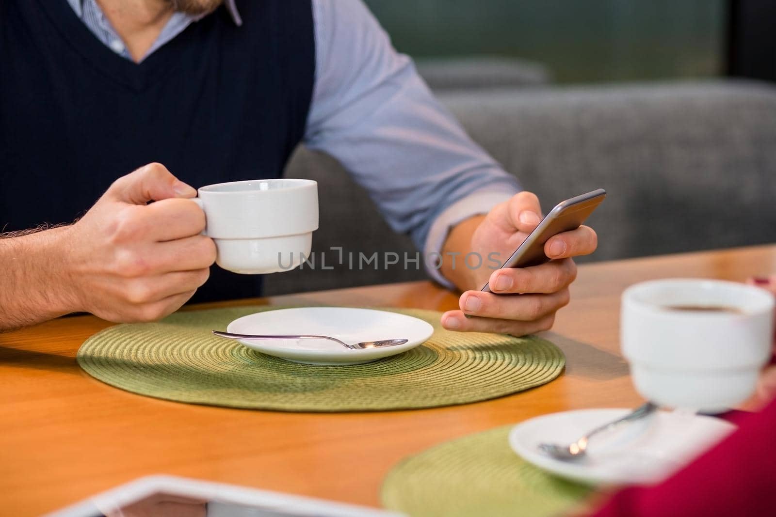 A woman and a man on a business lunch in a restaurant, drink coffee. Close up