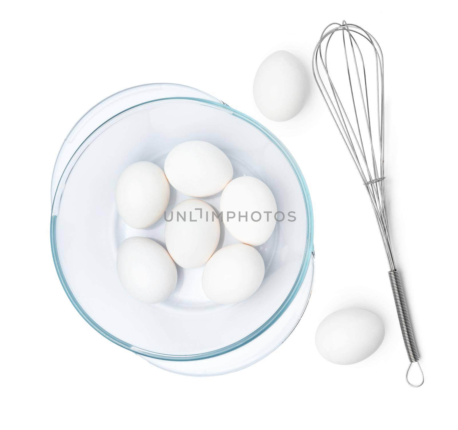 Fresh eggs with whisk isolated on white background, close up