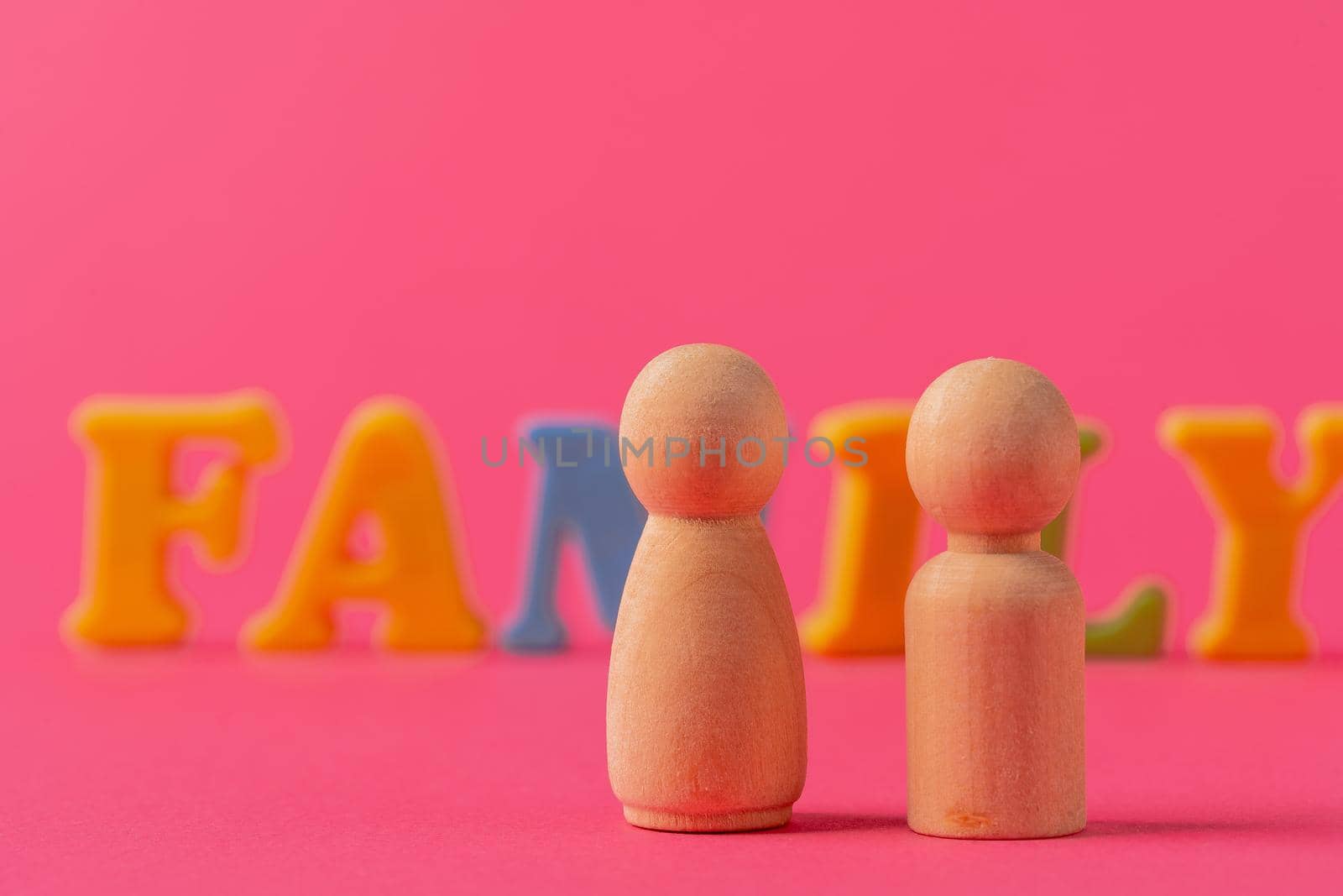 Wooden little figures of people close up. Family concept