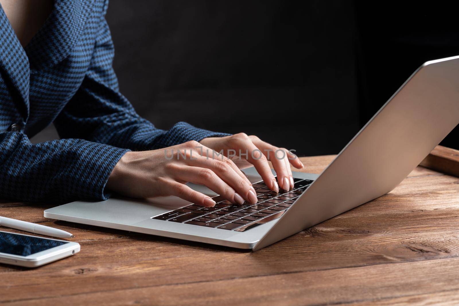 Business lady typing on laptop computer at wooden desk. Strategy planning and banking. Financial analyst working in office. Business accounting and project management. Close up woman hands on keyboard