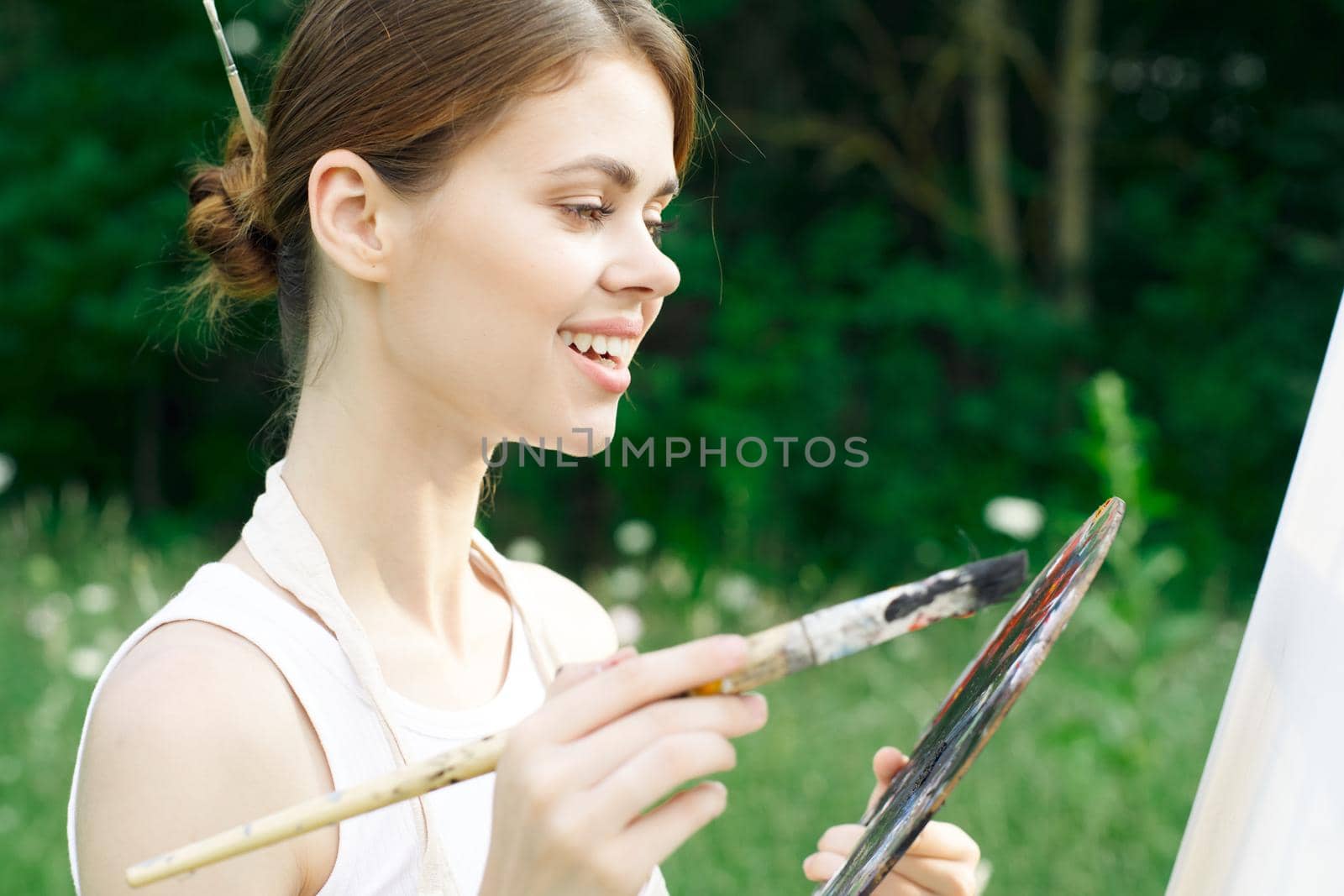 woman artist paints palette easel nature drawing by Vichizh