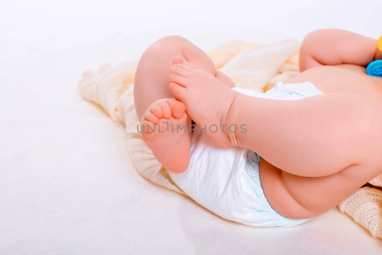 feet of a six months old baby wearing diapers by nazarovsergey