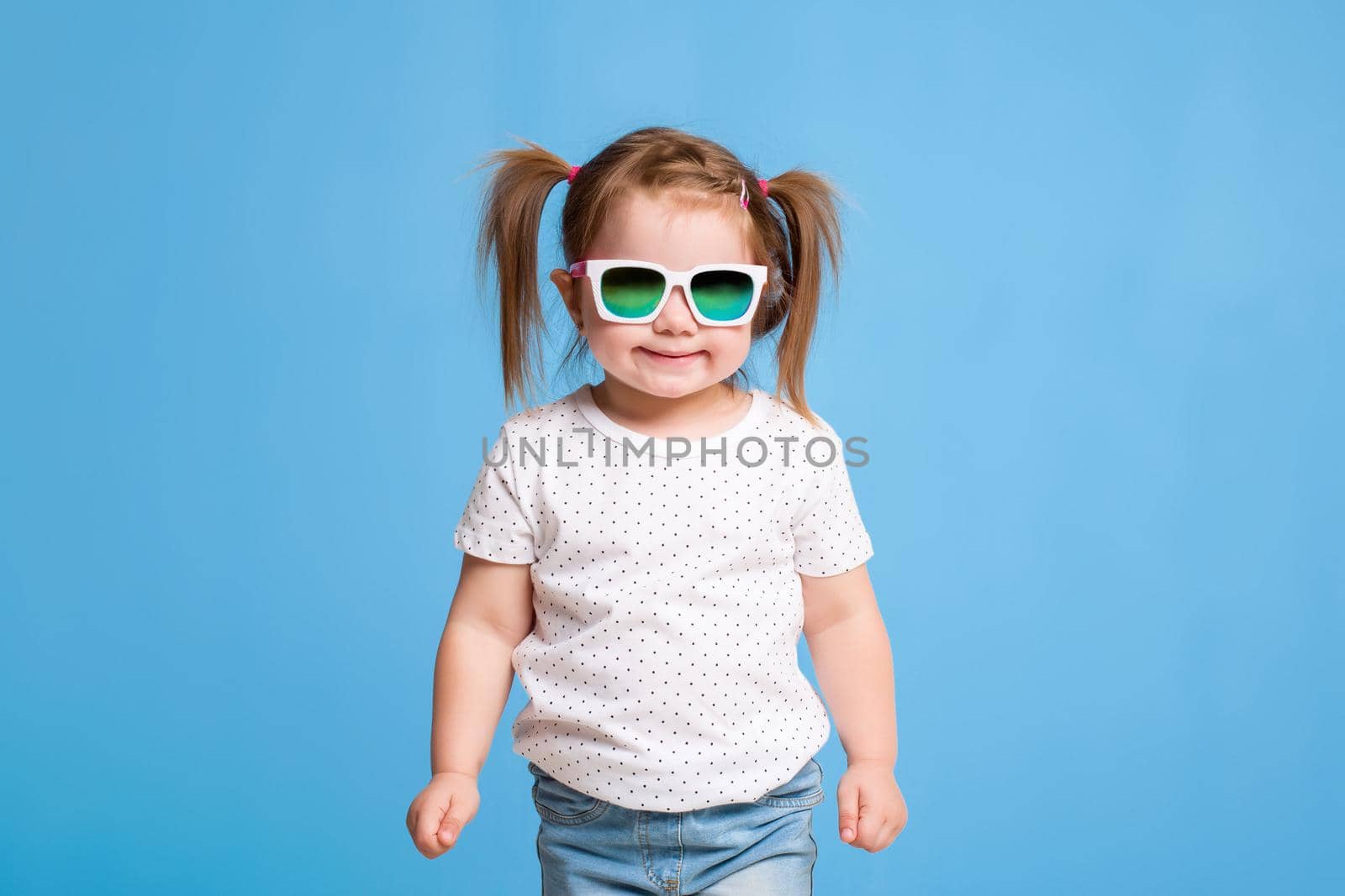 Fashion portrait of girl child on a blue background by nazarovsergey
