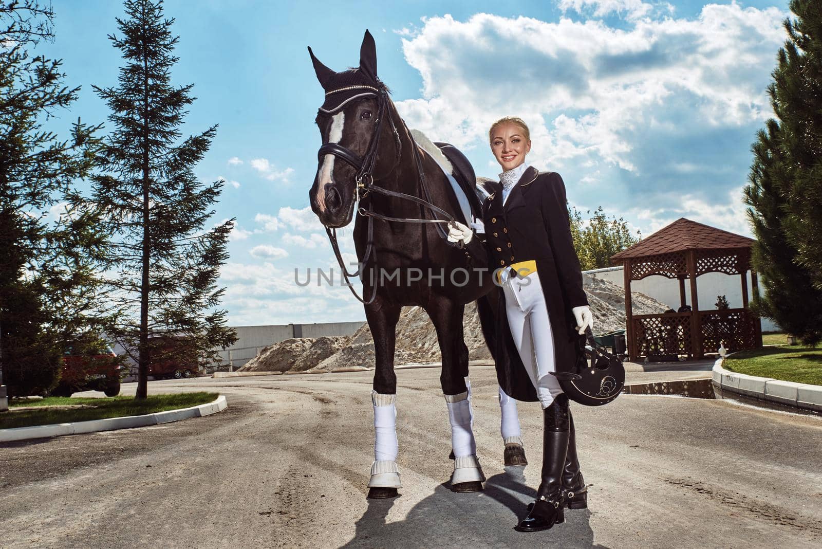 woman jockey with his horse in uniform for Dressage