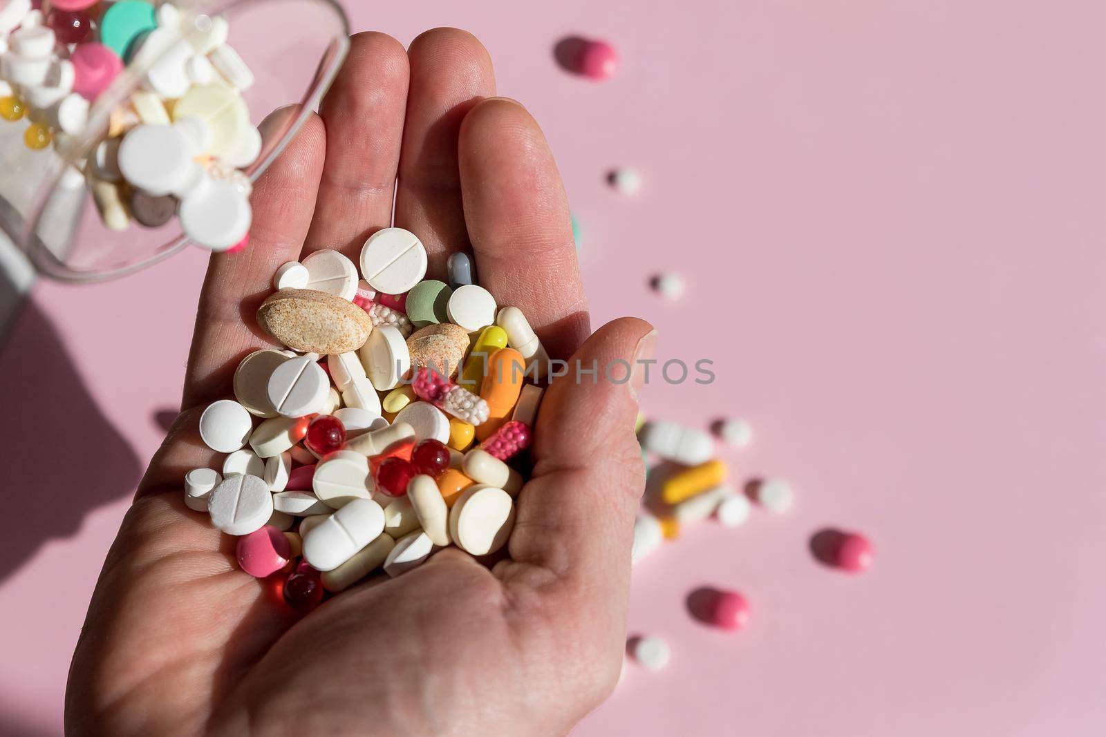 Prescription medicine pills pouring out of orange bottle on a table. selective focus