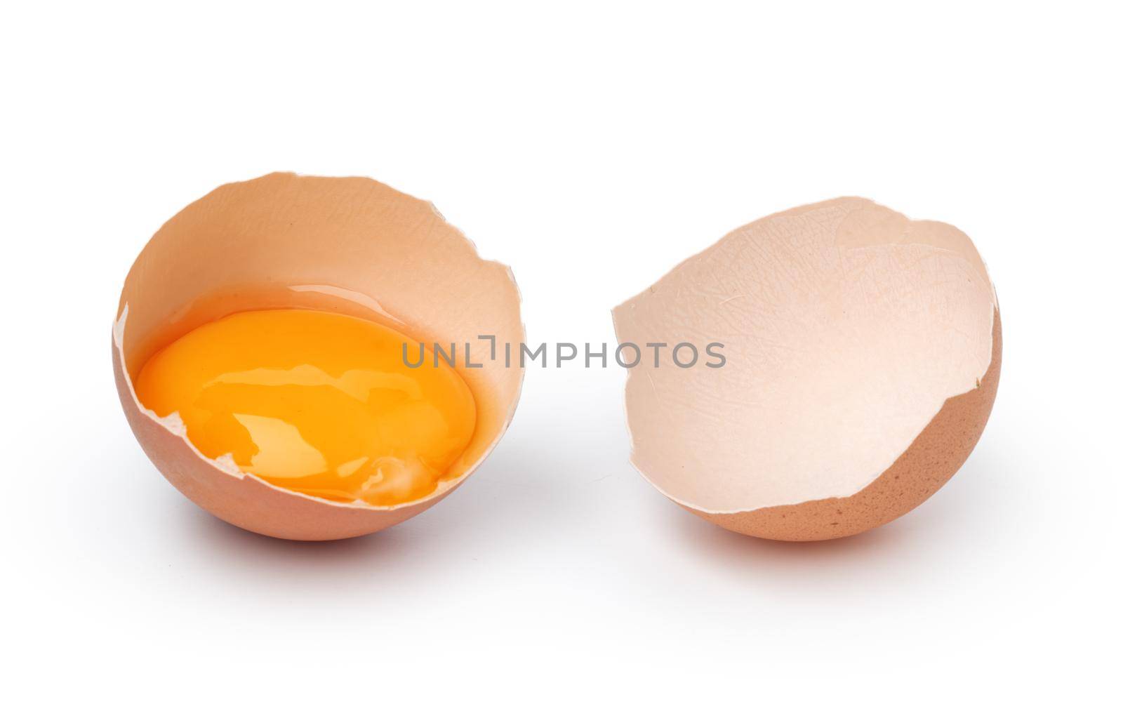 Brown raw eggs and one broken isolated on white background, close up