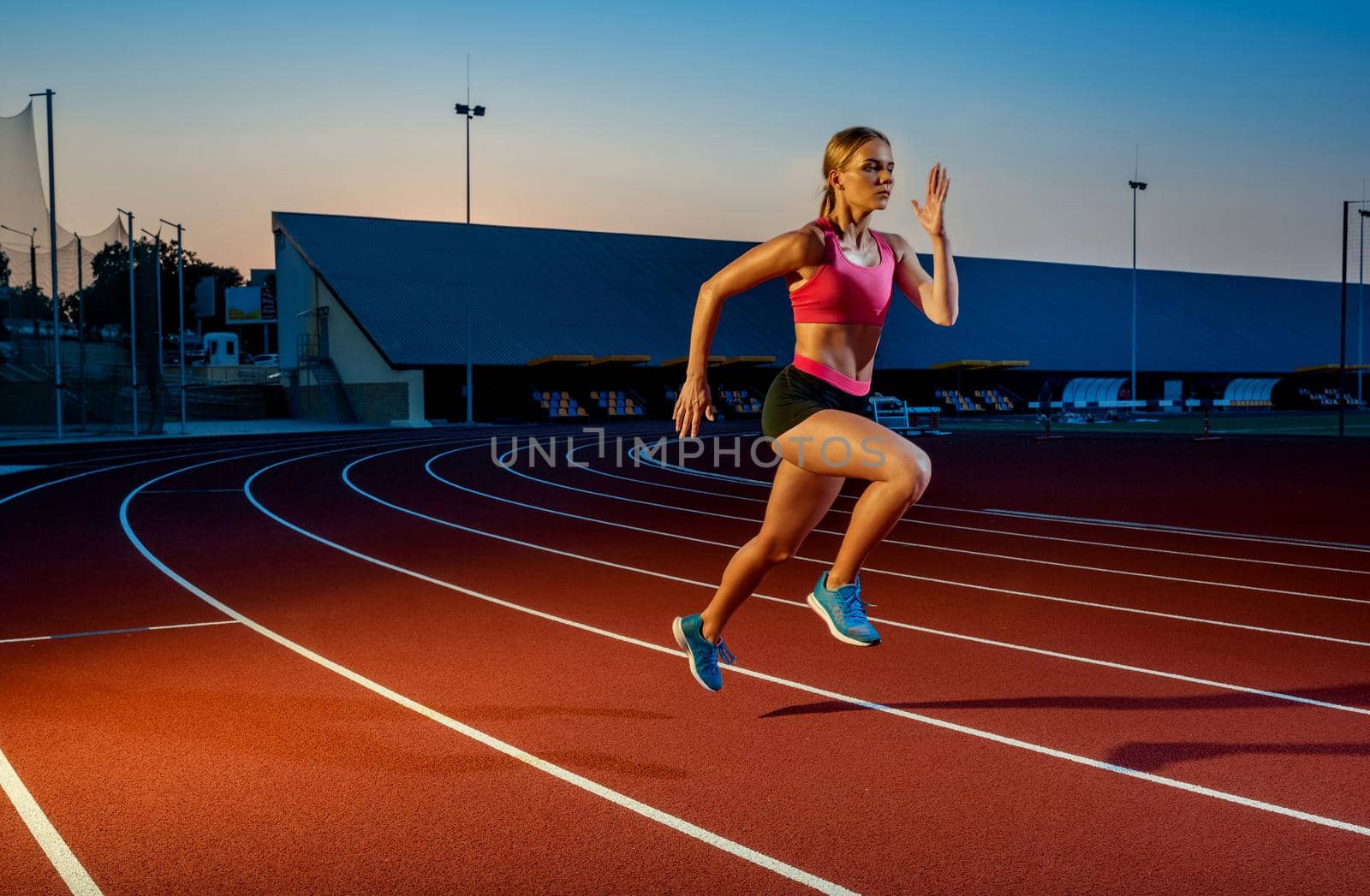 Runner sprinting towards success on run path running athletic track. Goal achievement concept. by nazarovsergey
