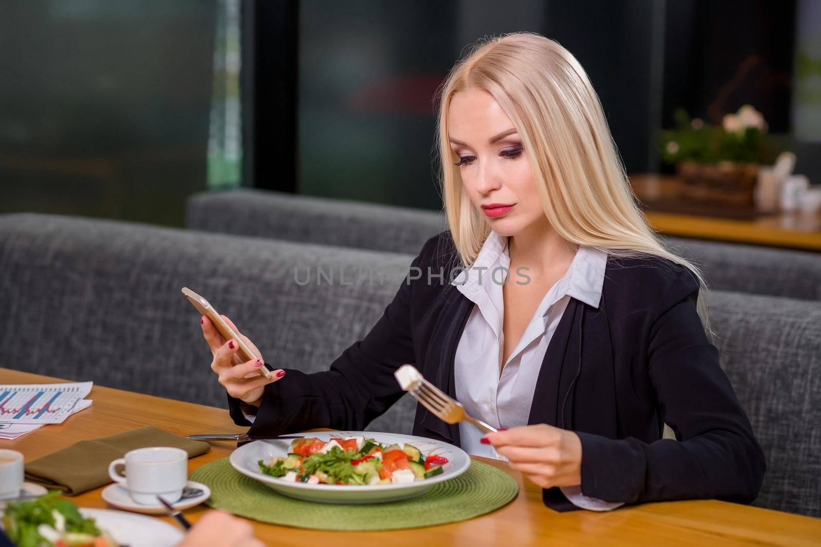 A woman and a man on a business lunch in a restaurant