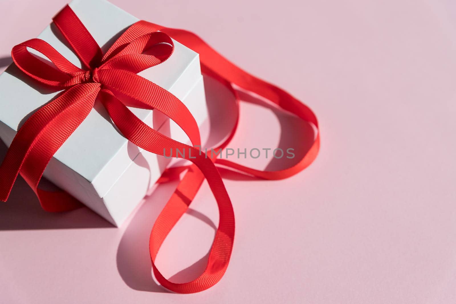 Red gift box with golden ribbon and bow