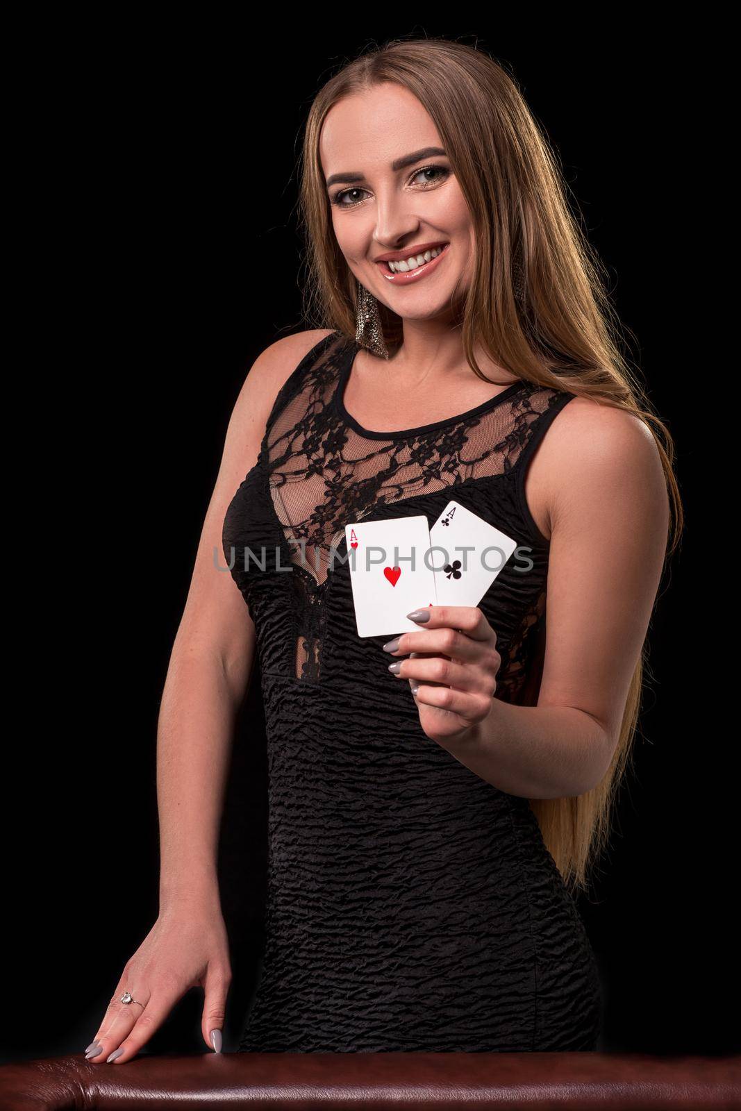Young beautiful woman playing in casino. Girl holding the winning combination of poker cards. Two aces by nazarovsergey