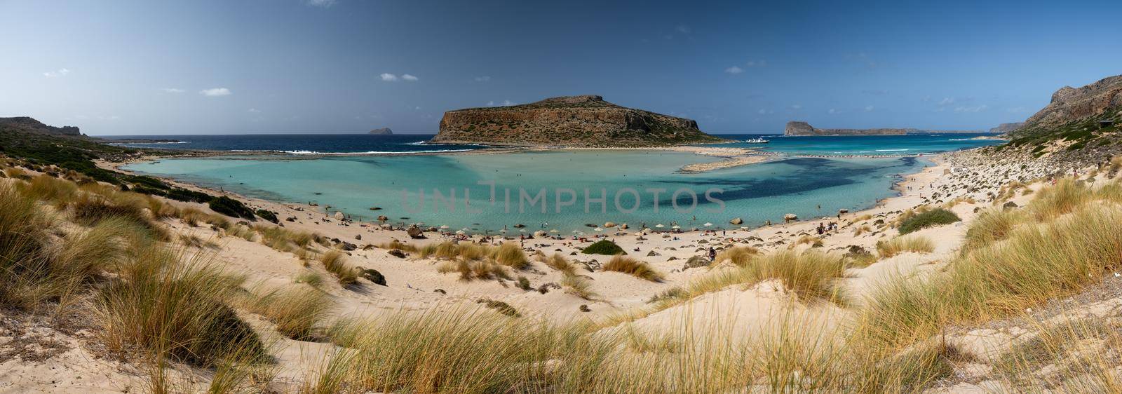 Crete Greece, Balos lagoon on Crete island, Greece. Tourists relax and bath in crystal clear water of Balos beach. Greece