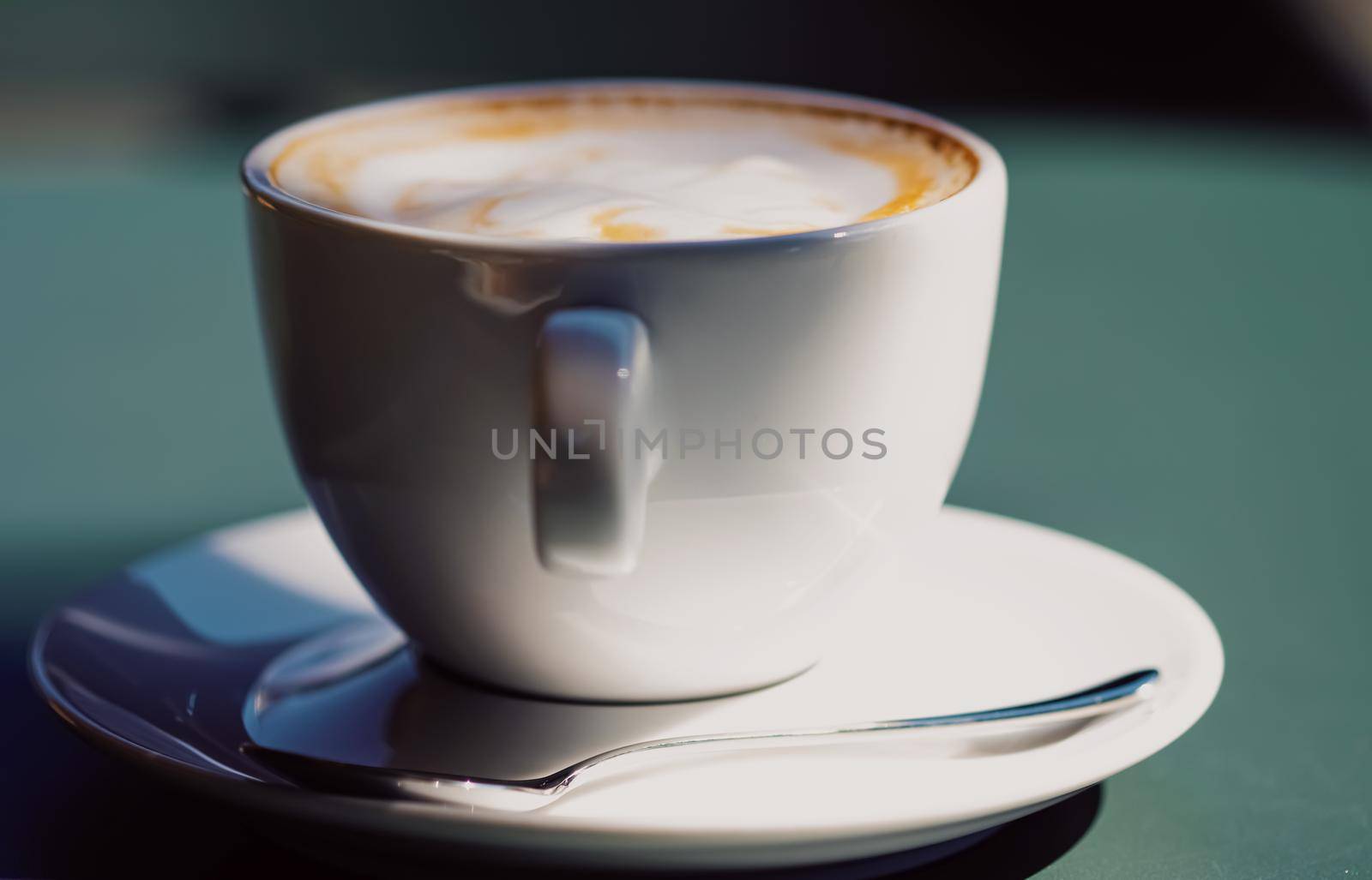 Cappuccino in summer cafe outdoors by Anneleven