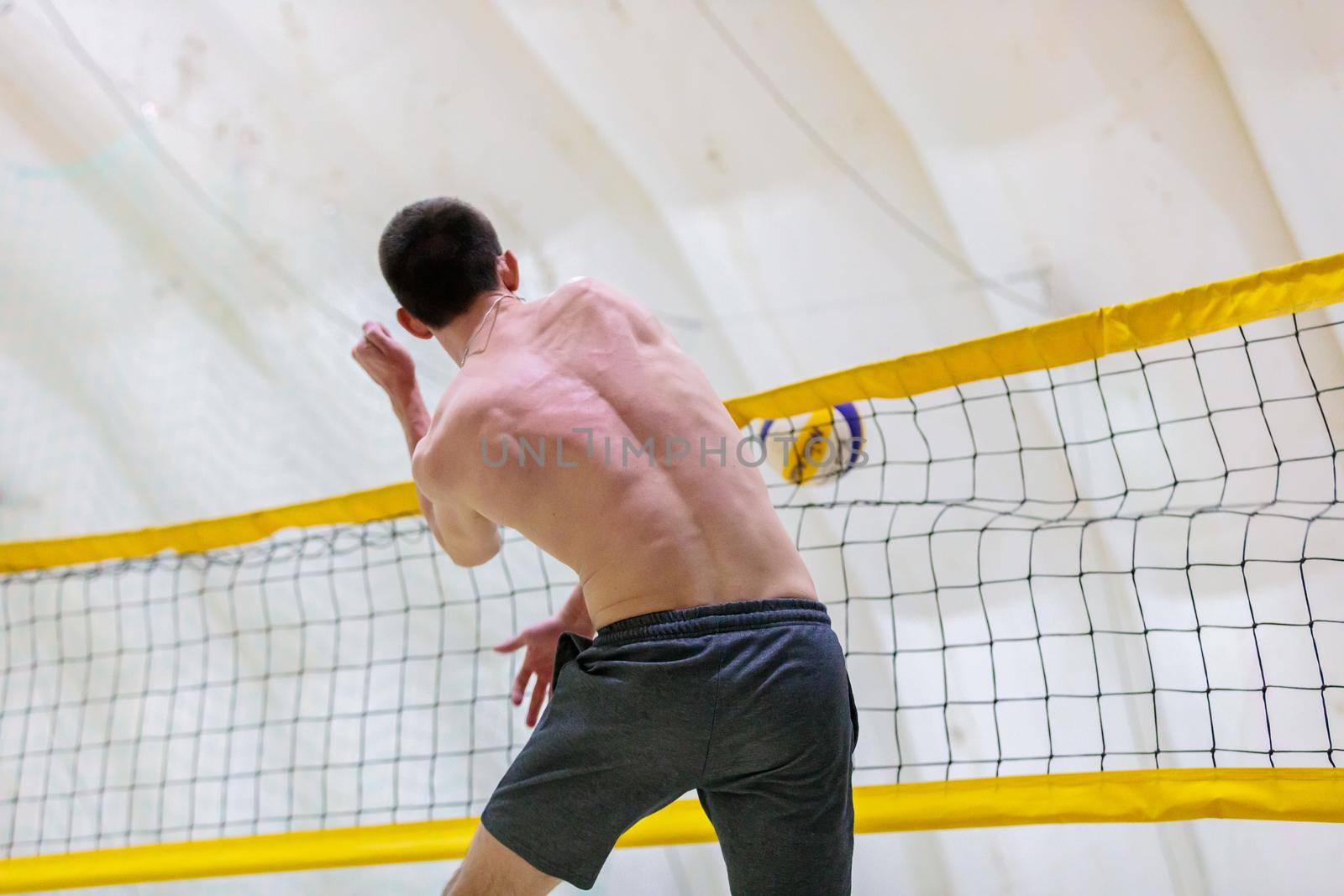 Man playing volleyball on the sand. Moscow Russia March 20, 2021