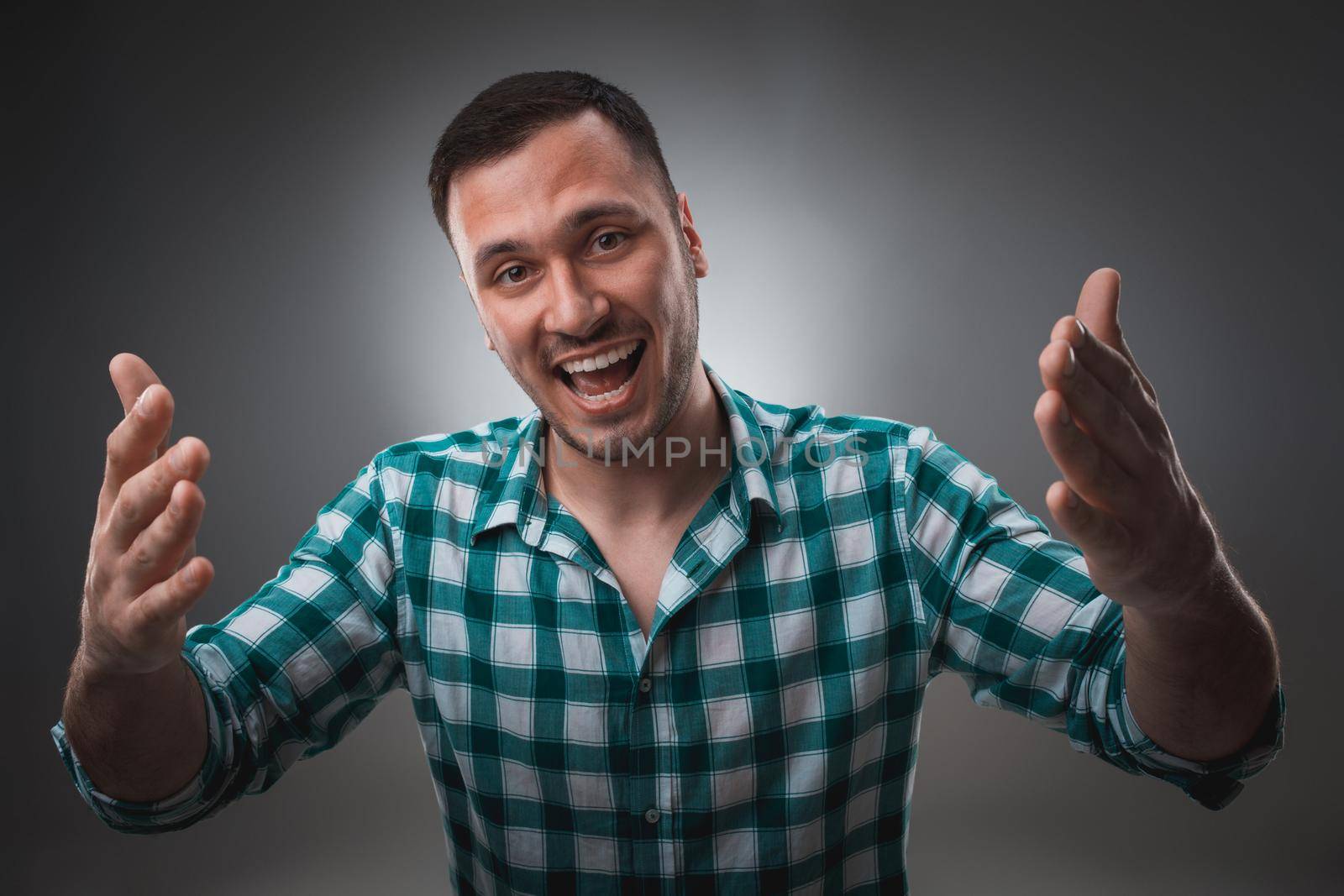 Portrait of excited man looking at the camera and points at you with a finger. by nazarovsergey