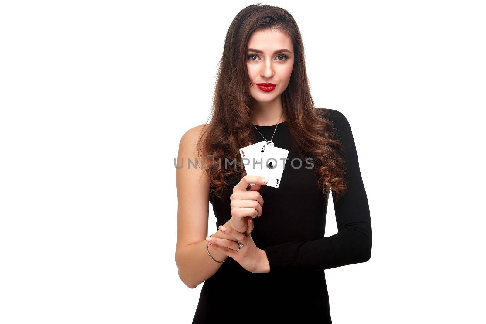 Sexy curly hair brunette in black dress posing with two aces cards in her hands, poker concept isolation on white background. winning combination