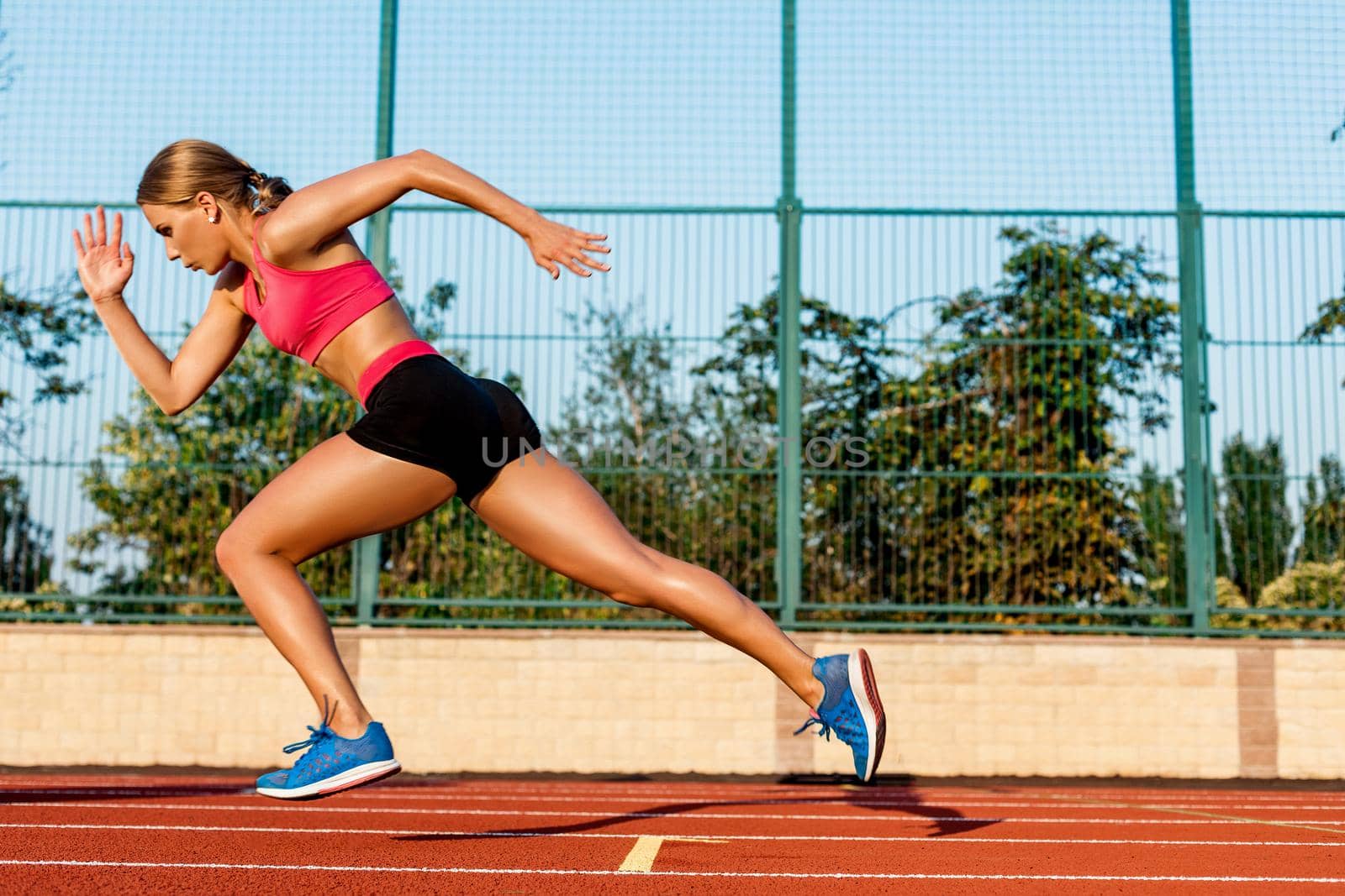 Runner sprinting towards success on run path running athletic track. Goal achievement concept. by nazarovsergey