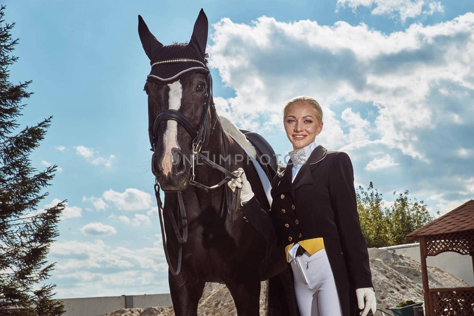 woman jockey with his horse in uniform for Dressage