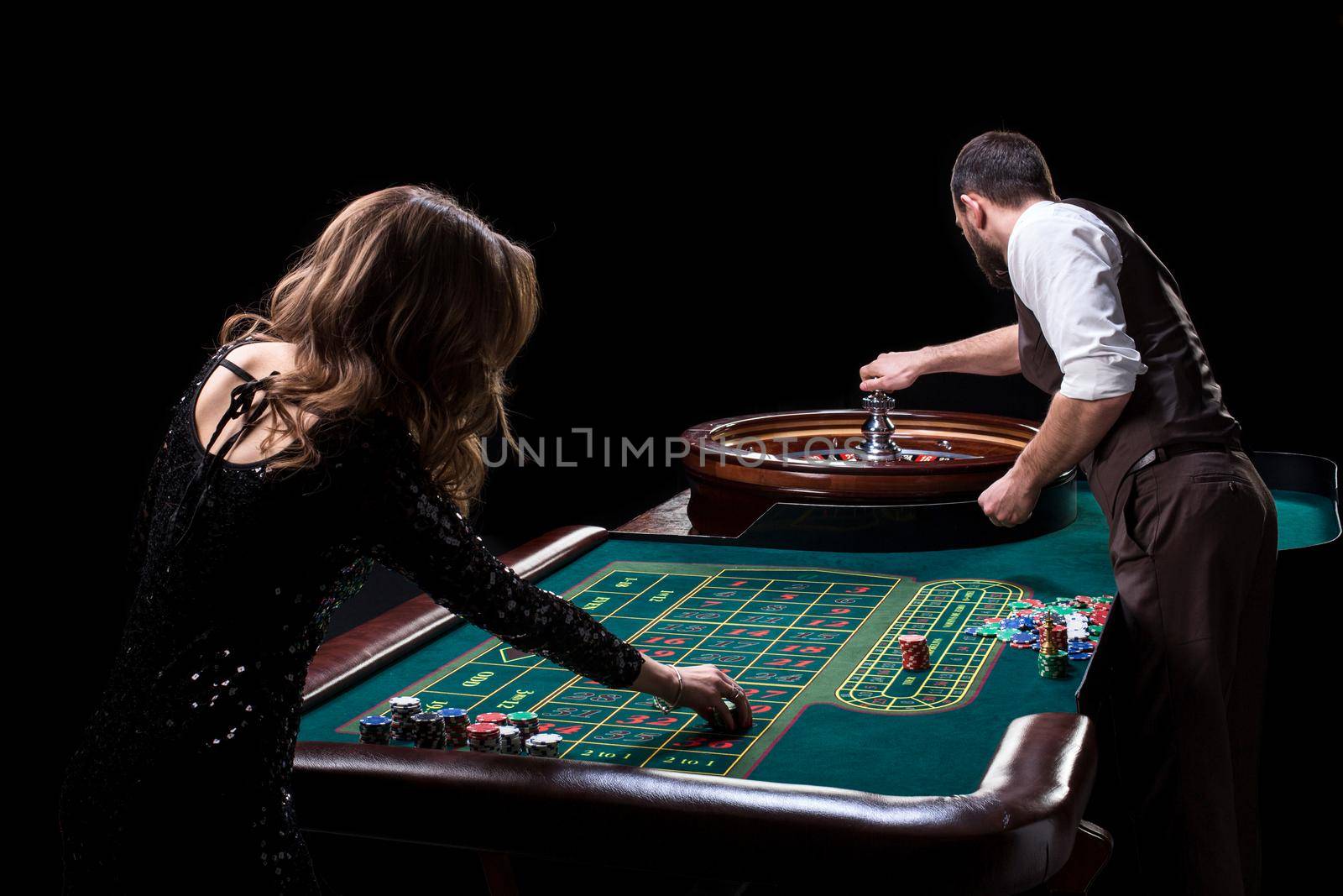 Croupier and woman player at a table in a casino. Picture of a c by nazarovsergey