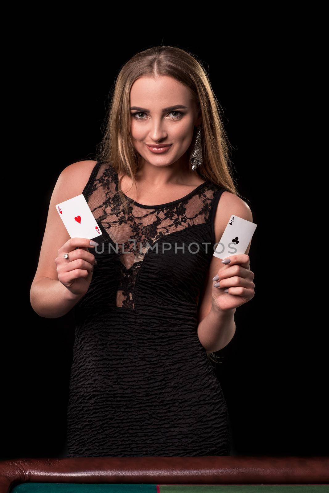 Young beautiful woman playing in casino. Girl holding the winning combination of poker cards. Two aces by nazarovsergey